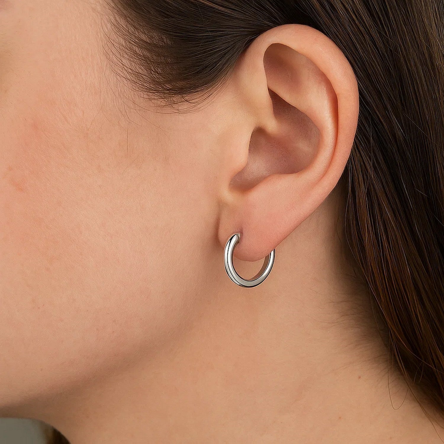 Polished 14k white gold round hoop earrings with a modern design, showcasing elegance and timeless style.