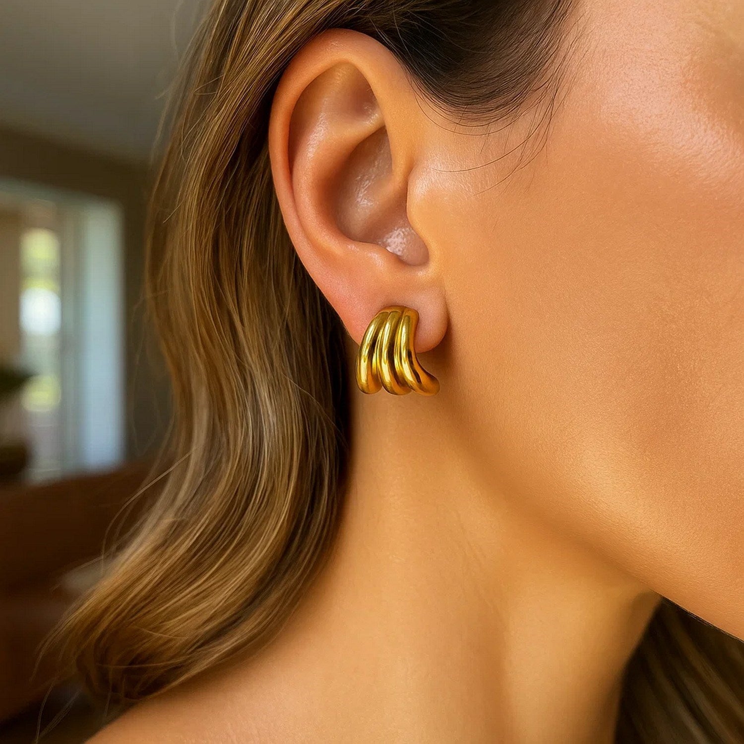 14k yellow gold modern triple row splayed hoop earrings showcasing elegant craftsmanship and contemporary design.