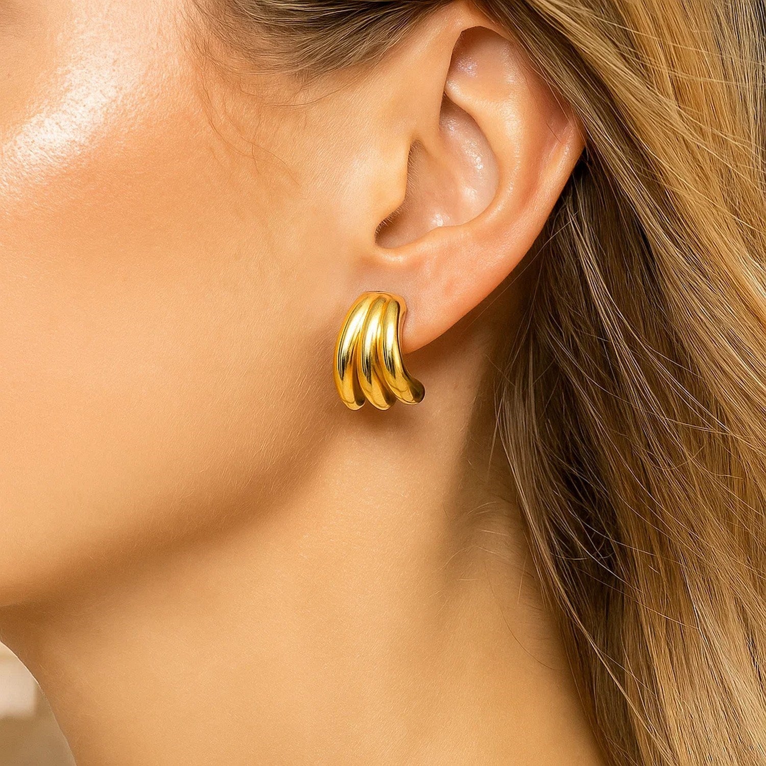 14k yellow gold modern triple row splayed hoop earrings showcasing elegant design and luxurious craftsmanship.