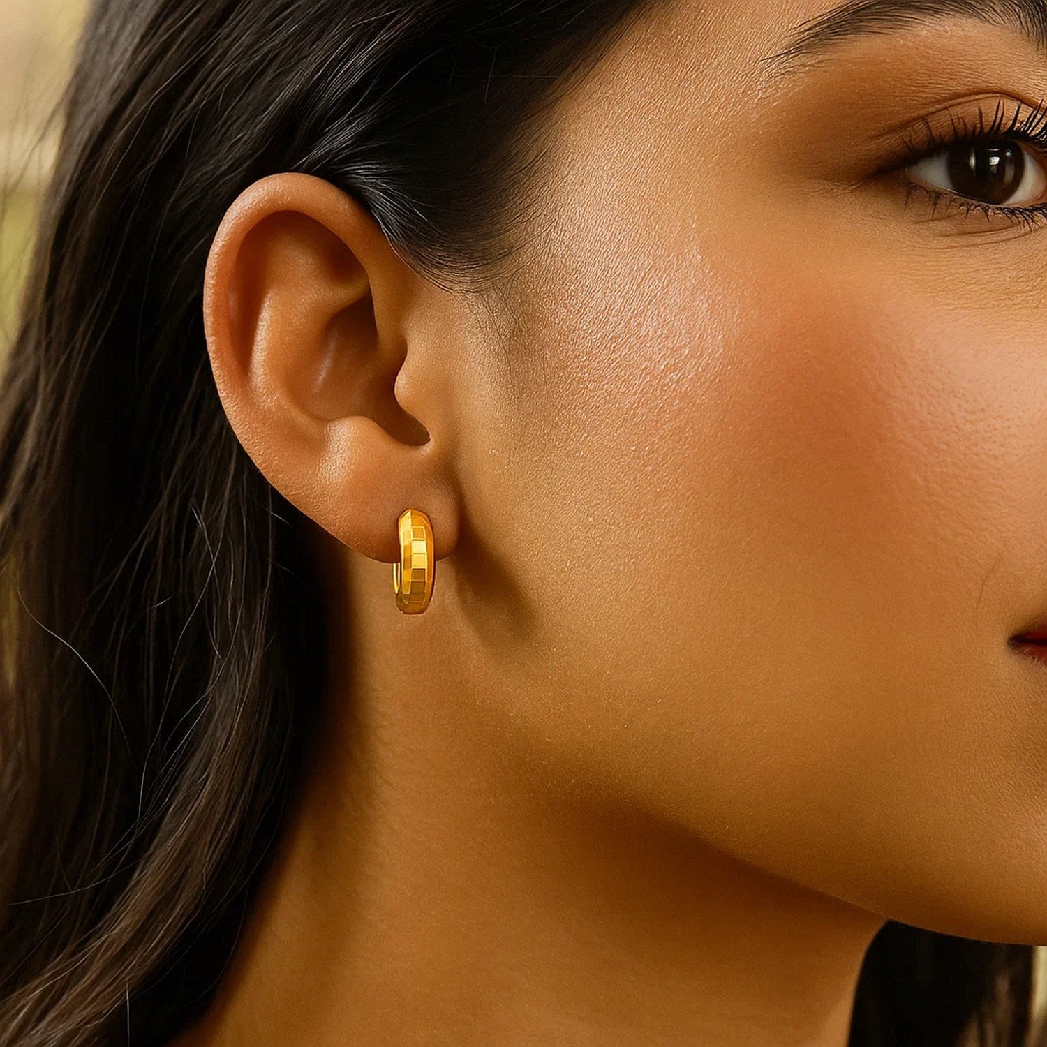 14K yellow gold polished huggie hoop earrings with a sleek modern design, perfect for everyday elegance.