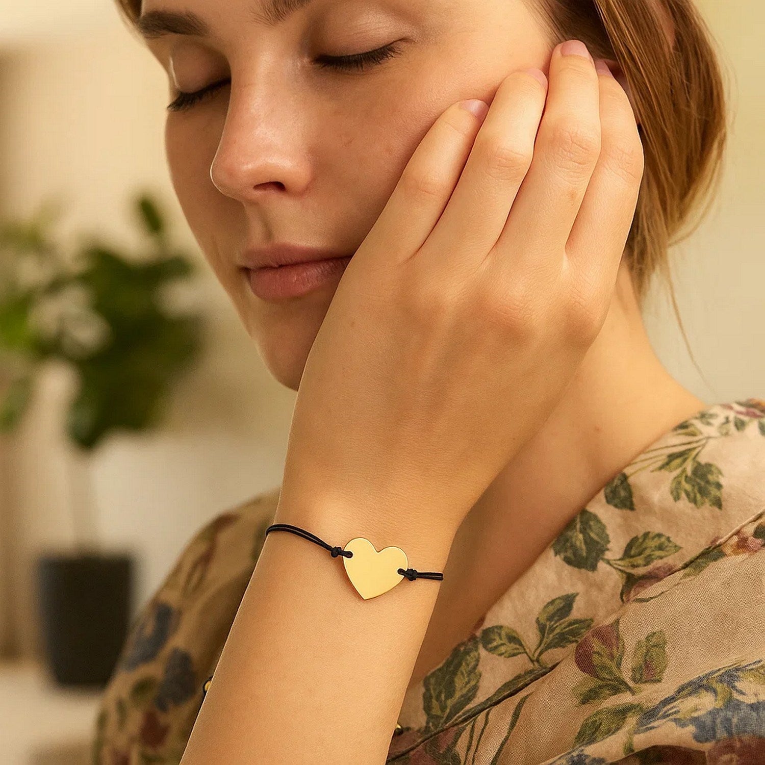 Elegant 9 1/4 inch black cord bracelet featuring a 14k yellow gold heart charm, perfect for luxury styling.