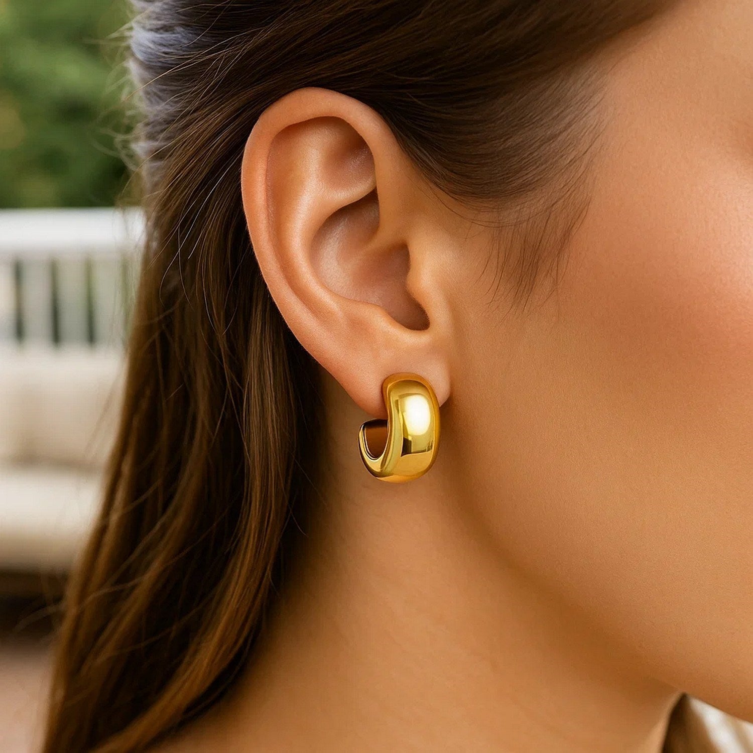 14K yellow gold polished hoop huggie earrings with a sleek modern design, perfect for elegant everyday wear.