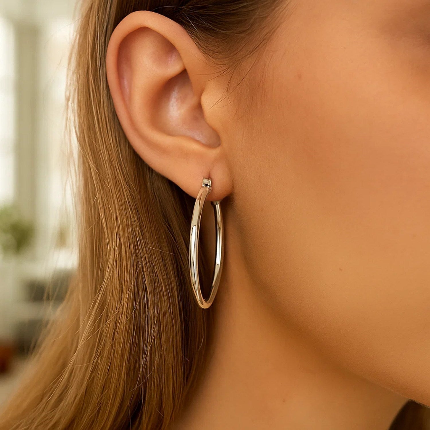 Sterling silver rhodium-plated polished classic hoop earrings with a modern design and elegant shine.