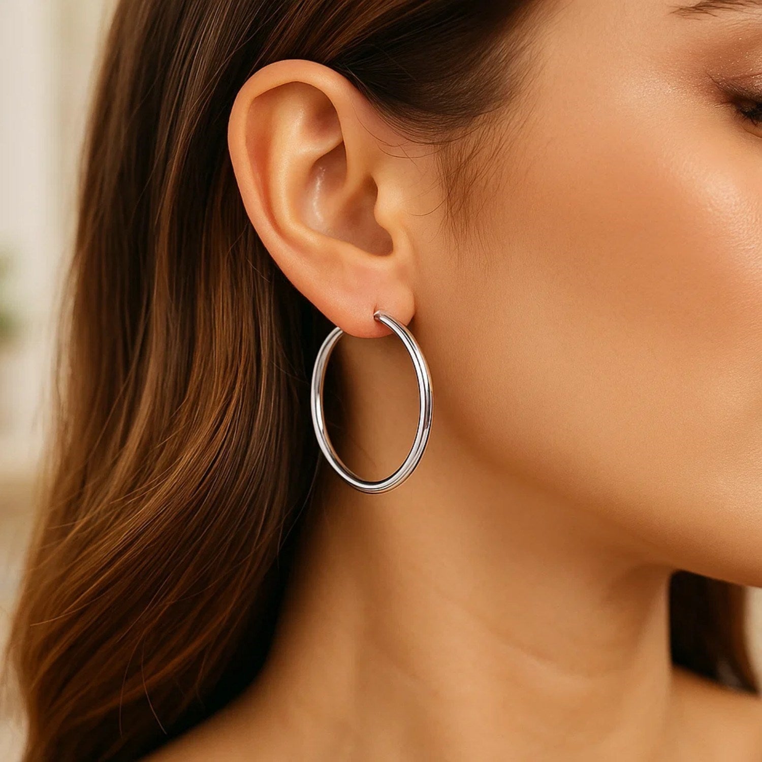 Sterling silver rhodium plated polished classic hoop earrings with a sleek modern design and elegant shine.