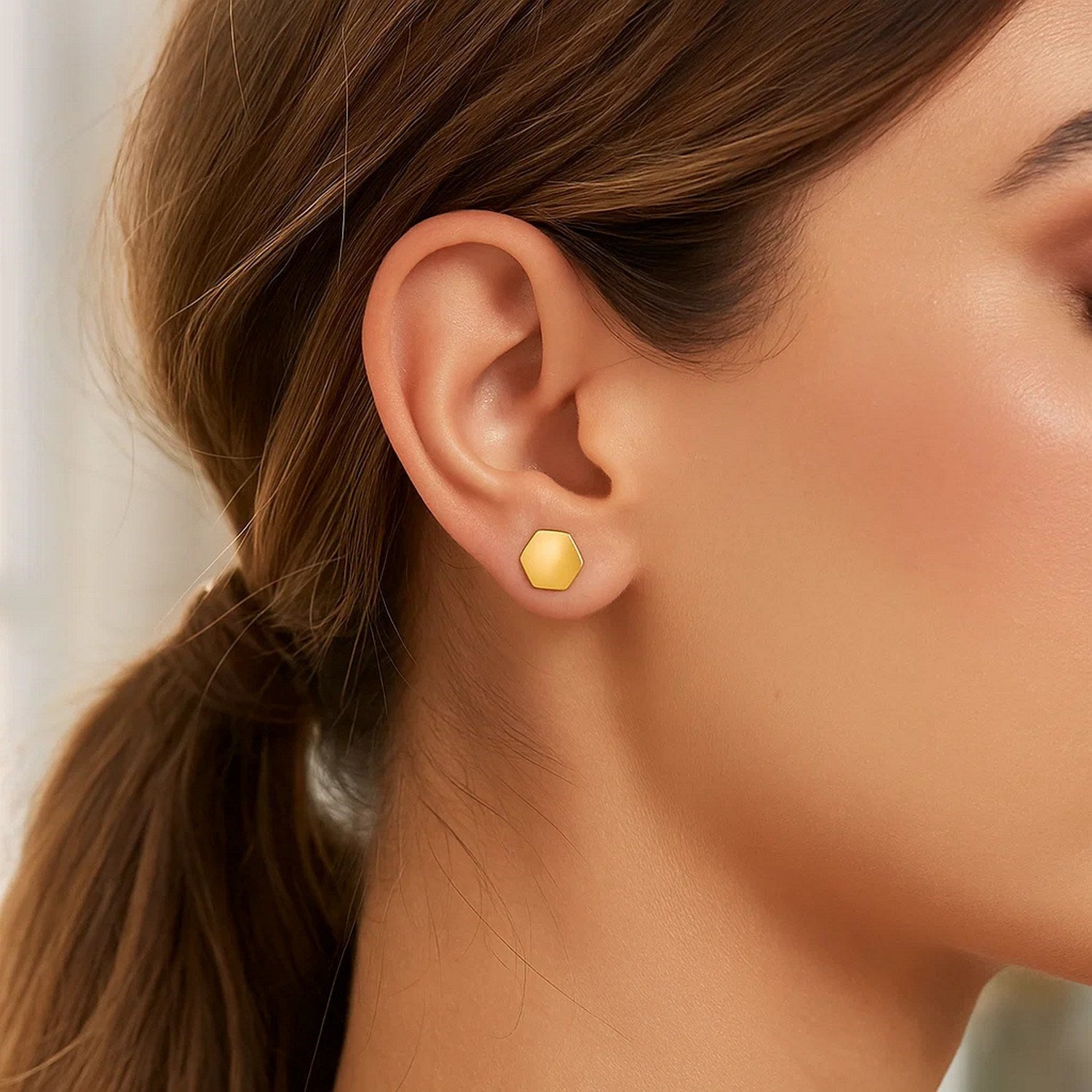14k yellow gold modern hexagon stud earrings showcasing a sleek, minimalist design for sophisticated elegance.