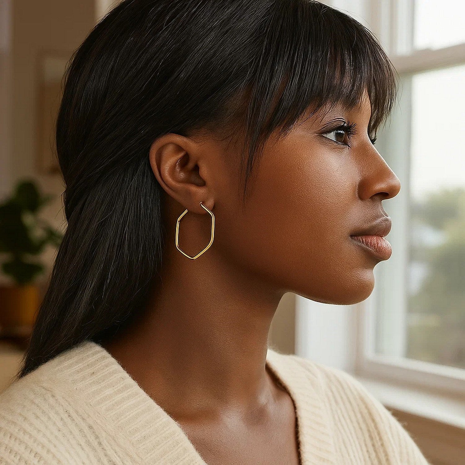 14K yellow gold hexagon hoop earrings with rounded edges, showcasing a modern and elegant design.