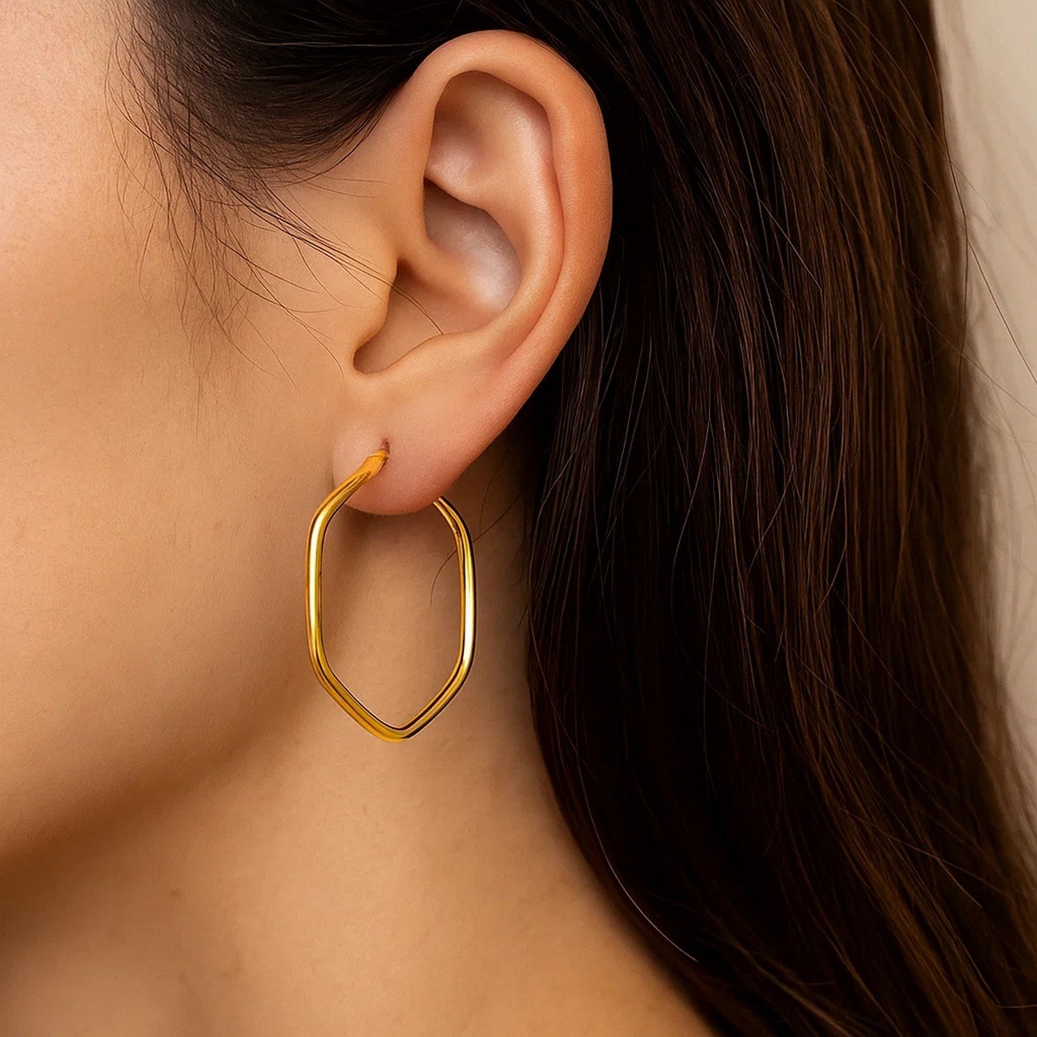 14k yellow gold modern hexagon hoop earrings with rounded edges, showcasing a sleek and elegant design.