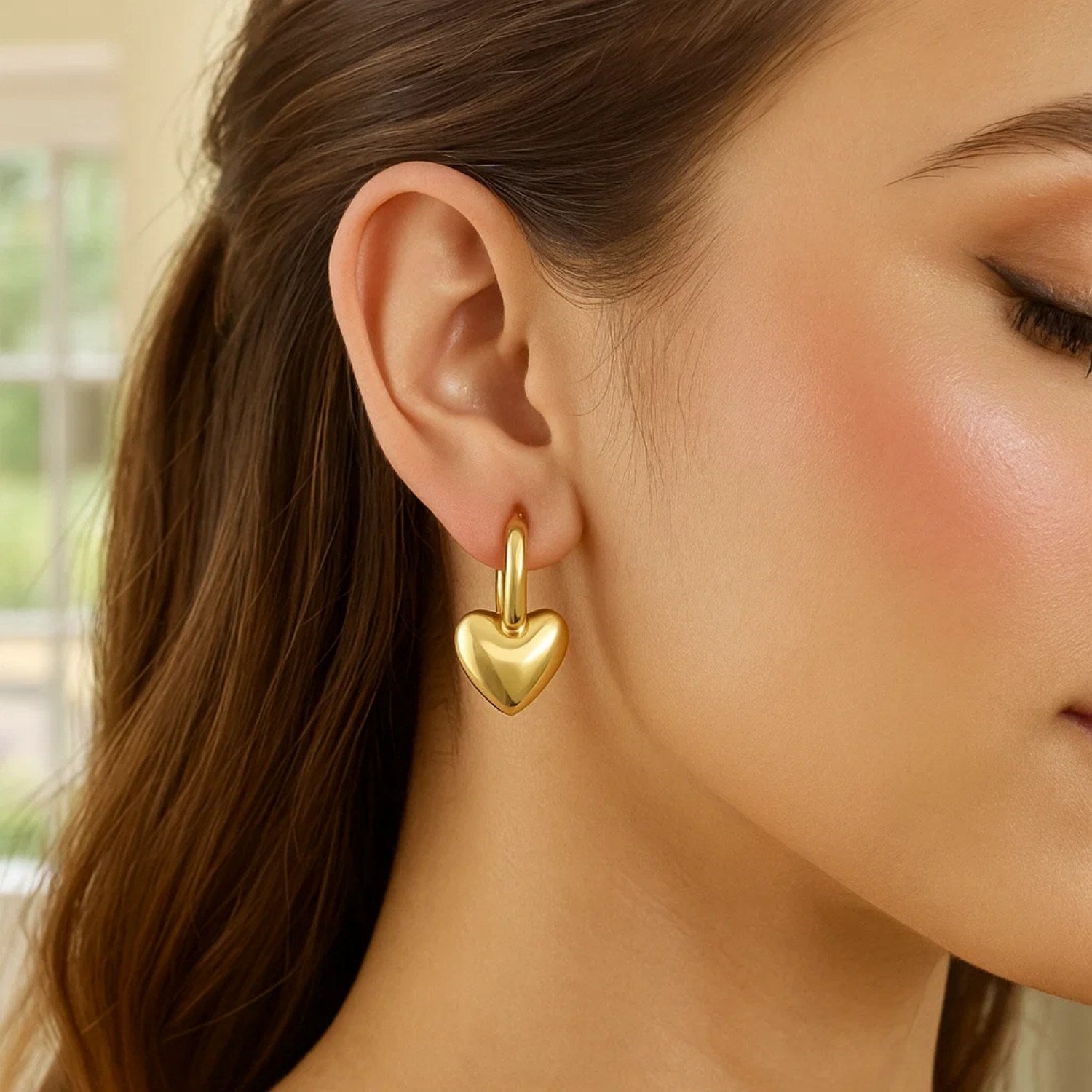 14k yellow gold puffy heart dangle huggie earrings with modern hoop design, perfect for elegant occasions.