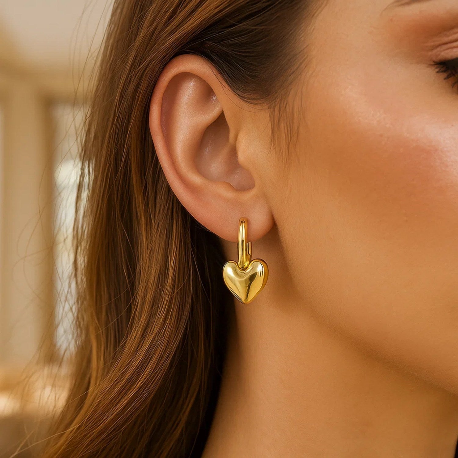 14K yellow gold puffy heart dangle huggie earrings with modern hoop design, perfect for elegant occasions.