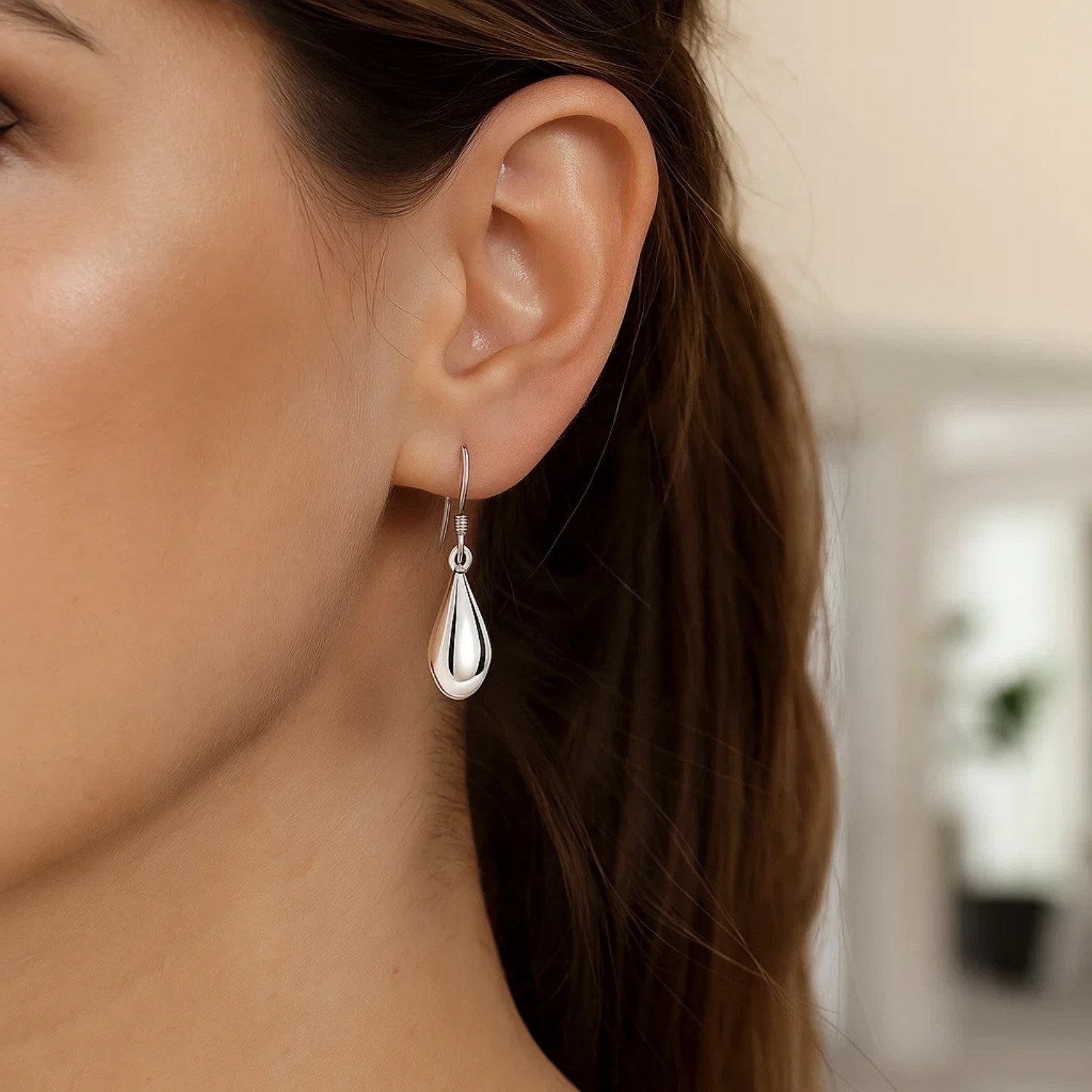Sterling silver polished puffed teardrop earrings with modern dangle design, perfect for elegant occasions.