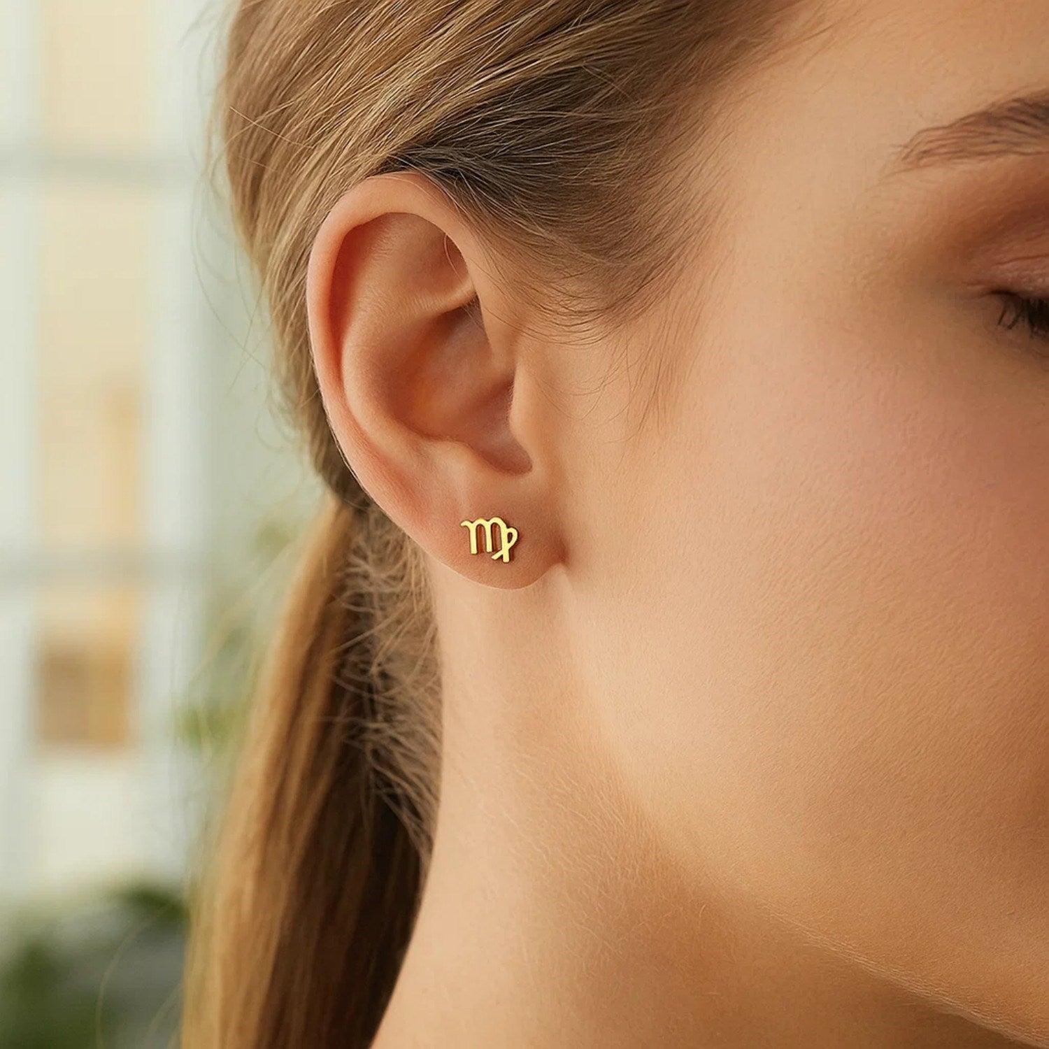 Minimalist 14k yellow gold stud earrings featuring a sleek design, perfect for elegant everyday wear.