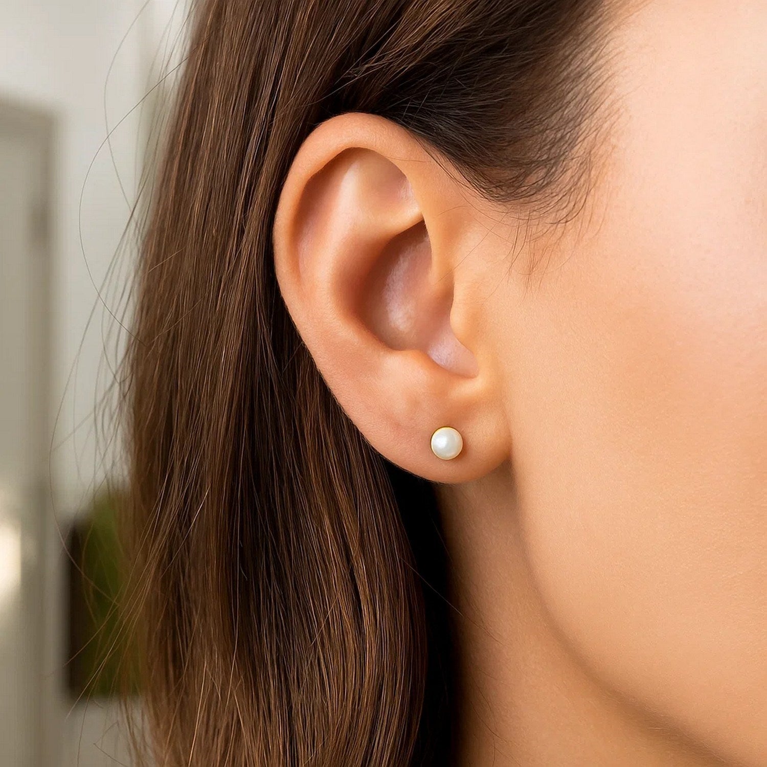 Elegant 14k yellow gold stud earrings featuring 4mm freshwater cultured pearls for a timeless luxury look.