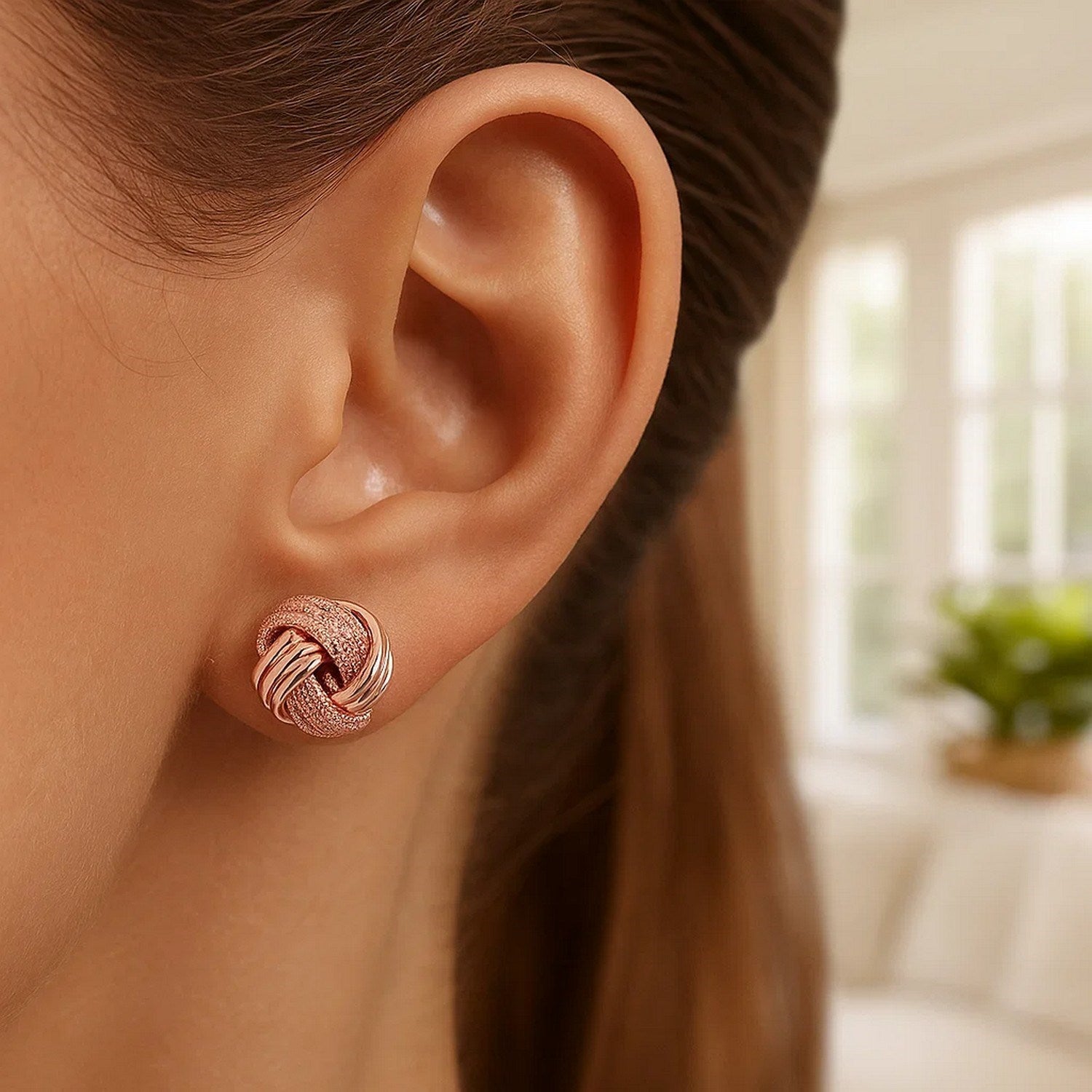 14k rose gold textured love knot earrings showcasing modern elegance and luxurious craftsmanship.