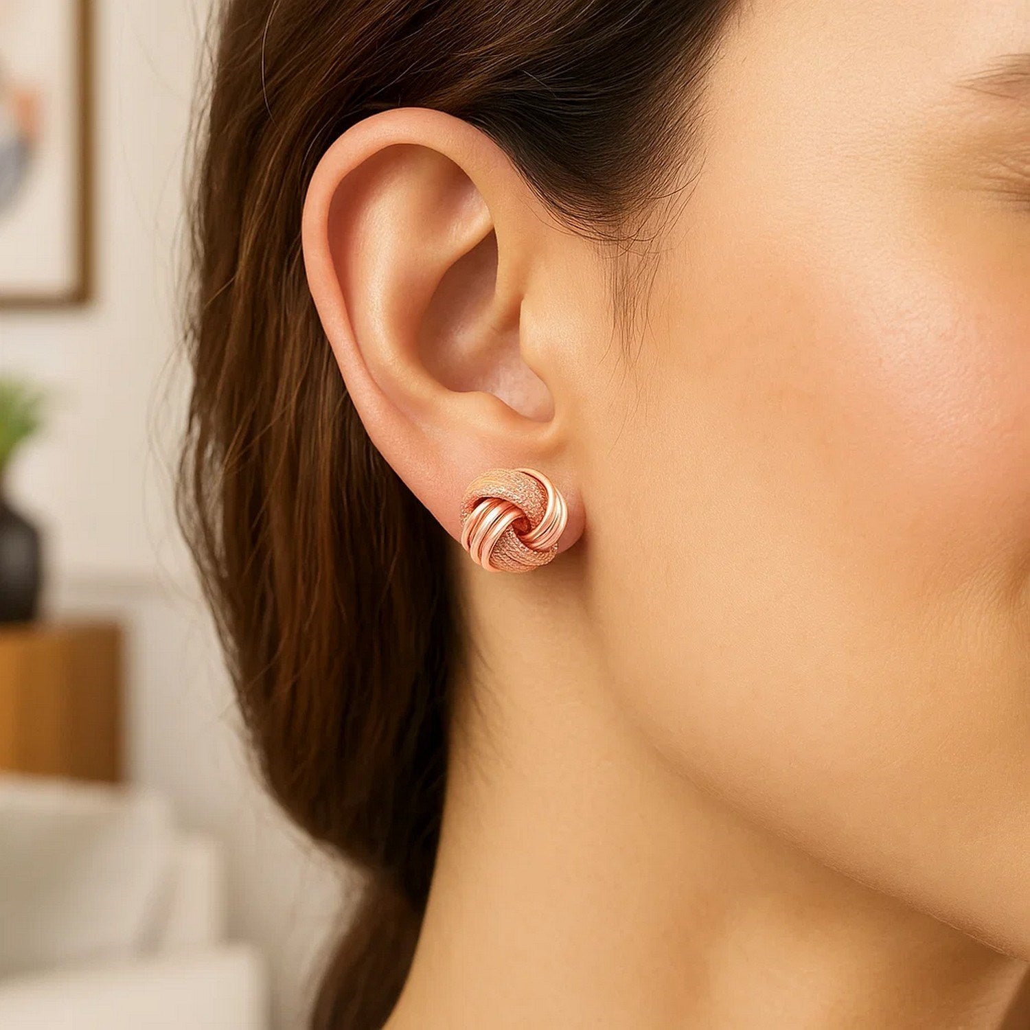 14k rose gold textured love knot earrings with a modern design, perfect for adding elegance to any outfit.