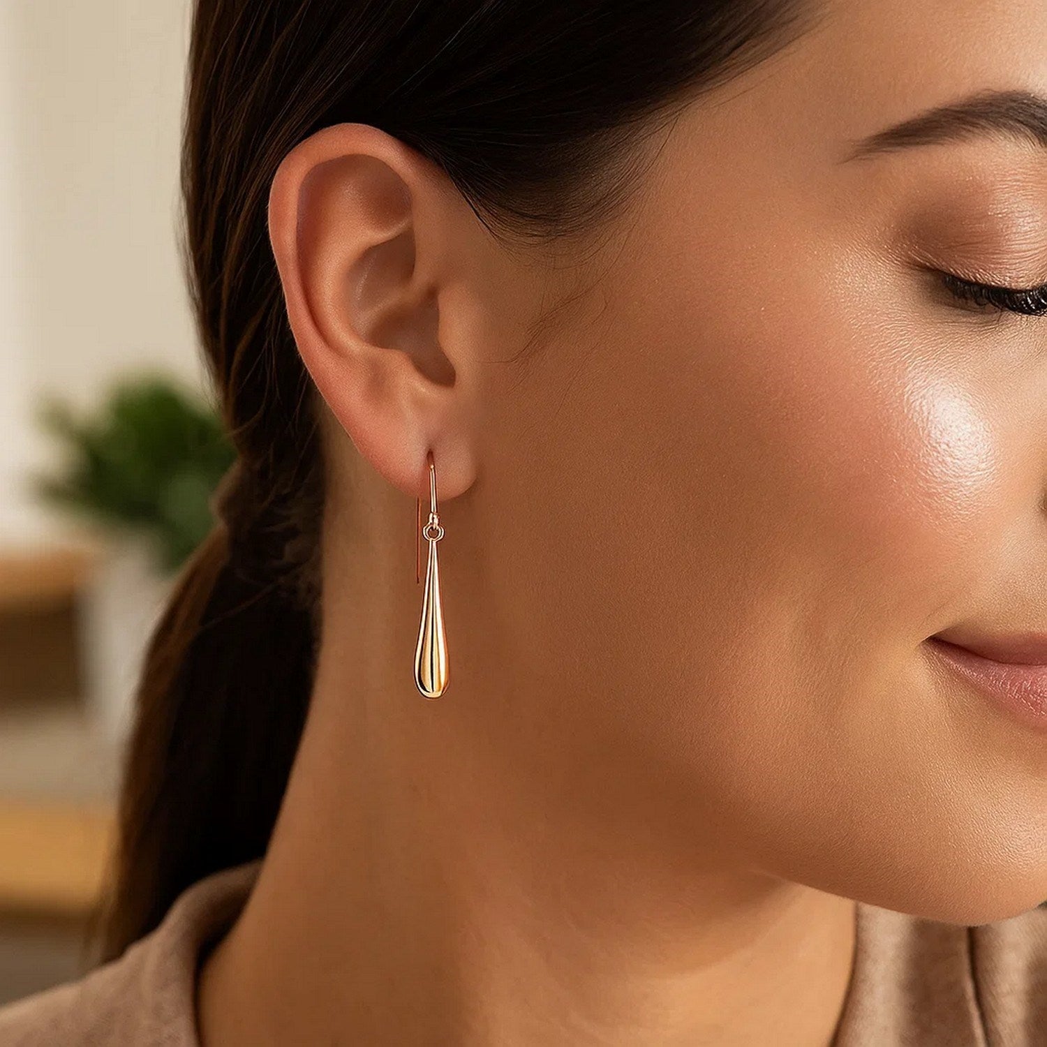 14k rose gold polished teardrop dangle earrings with a modern design, perfect for elegant occasions.
