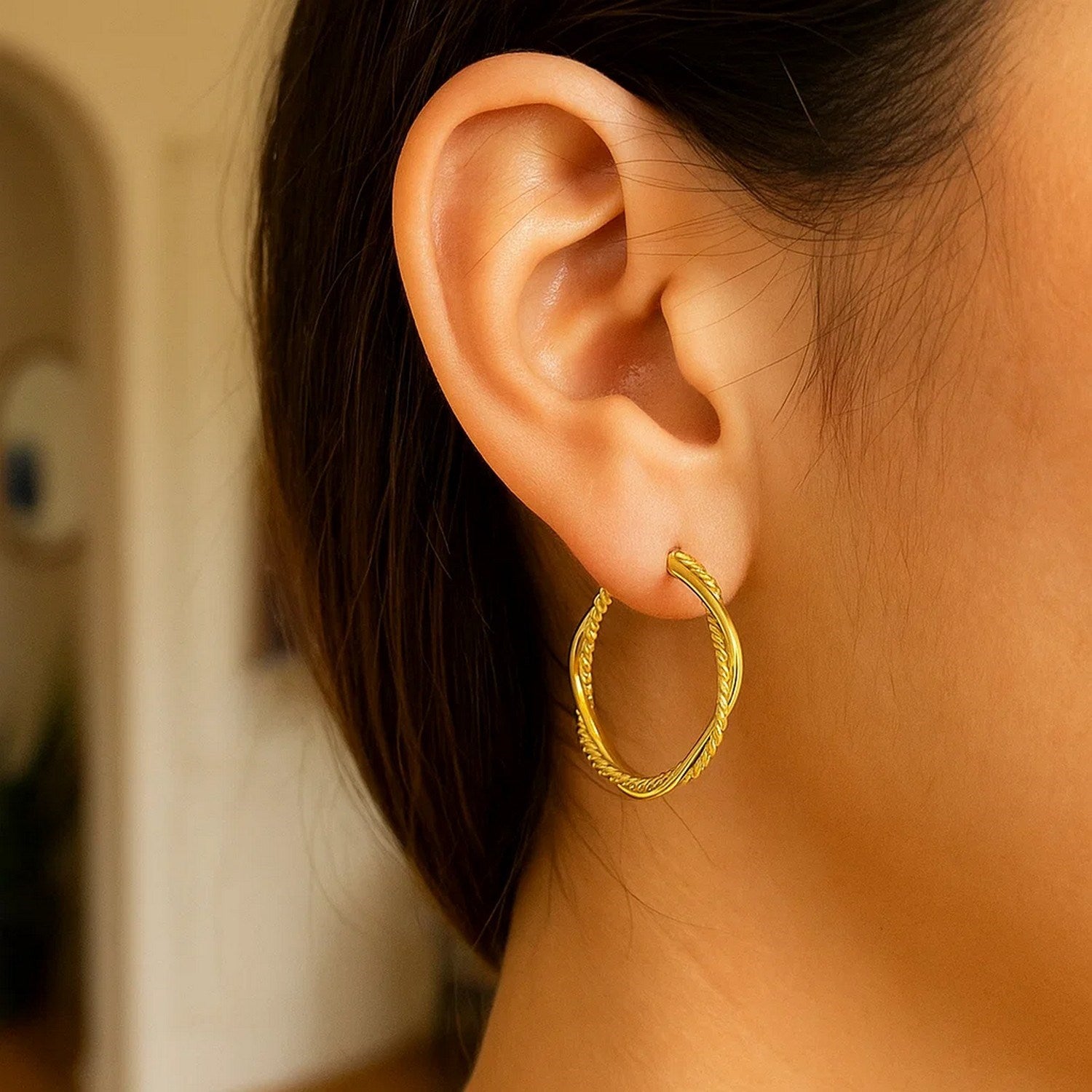 14k yellow gold textured twisted round hoop earrings, showcasing a classic design for timeless elegance.