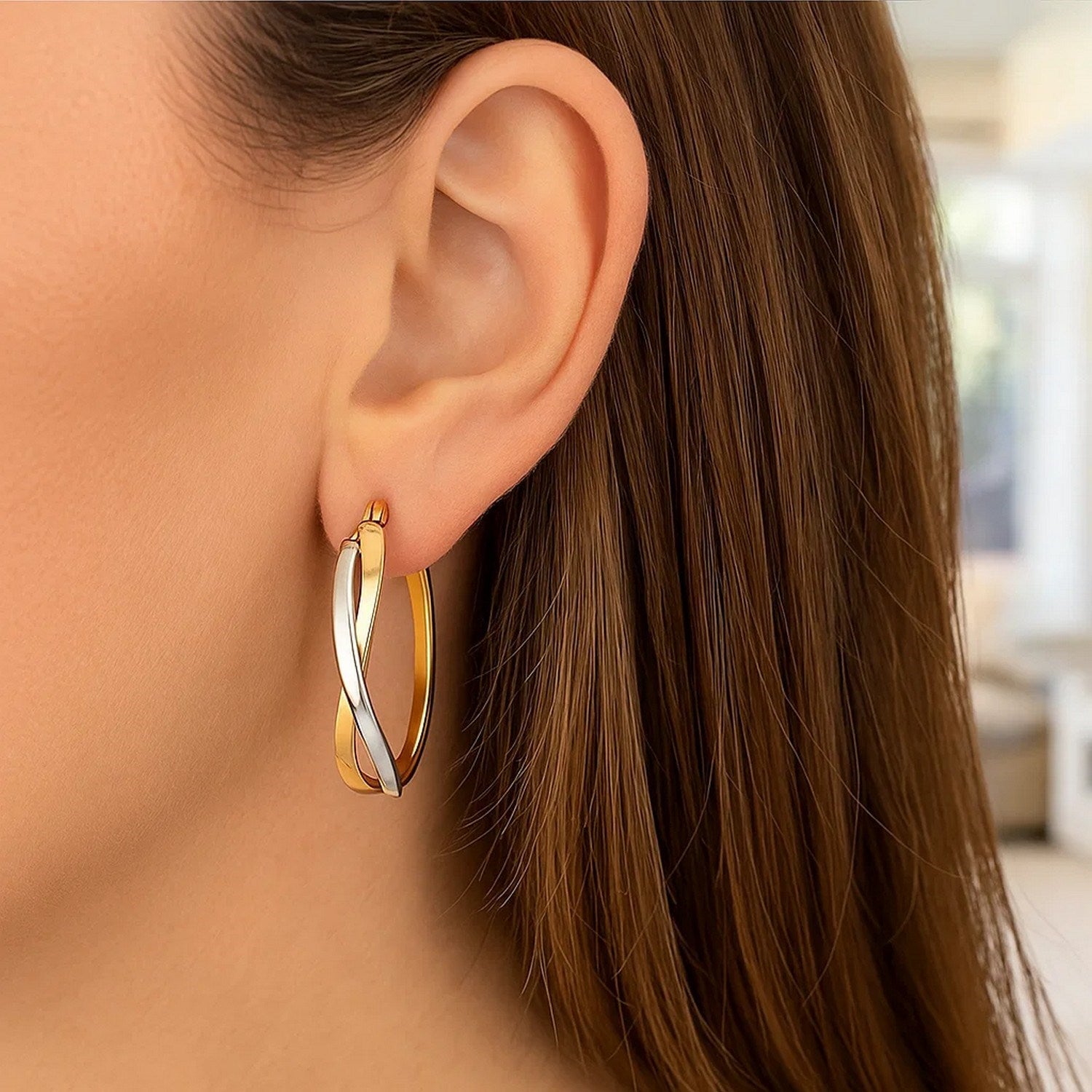 14k two-tone gold polished twisted hoop earrings showcasing a modern design with a luxurious finish.