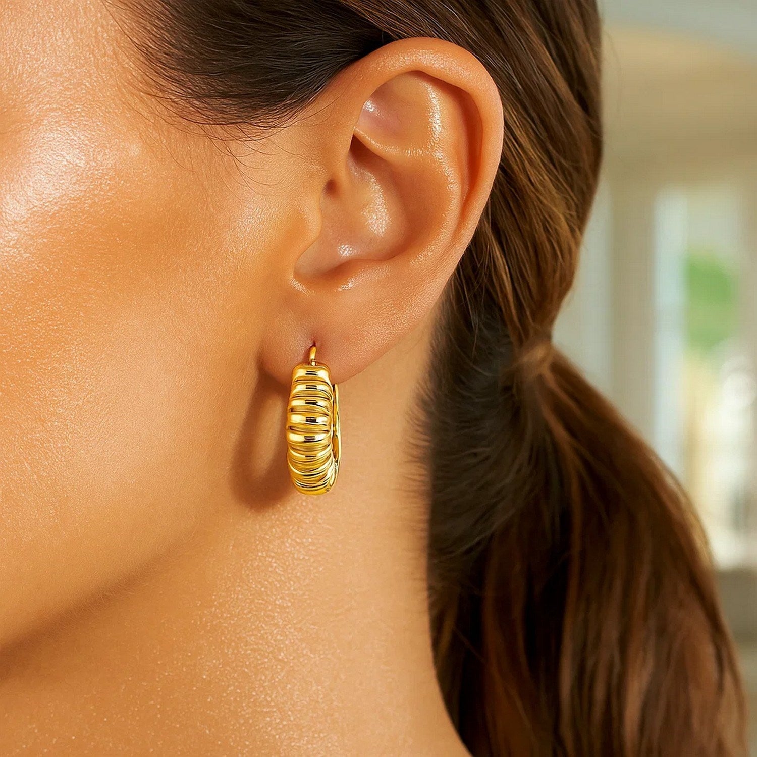 14K yellow gold polished puffed ribbed hoop earrings exuding elegance and timeless luxury.