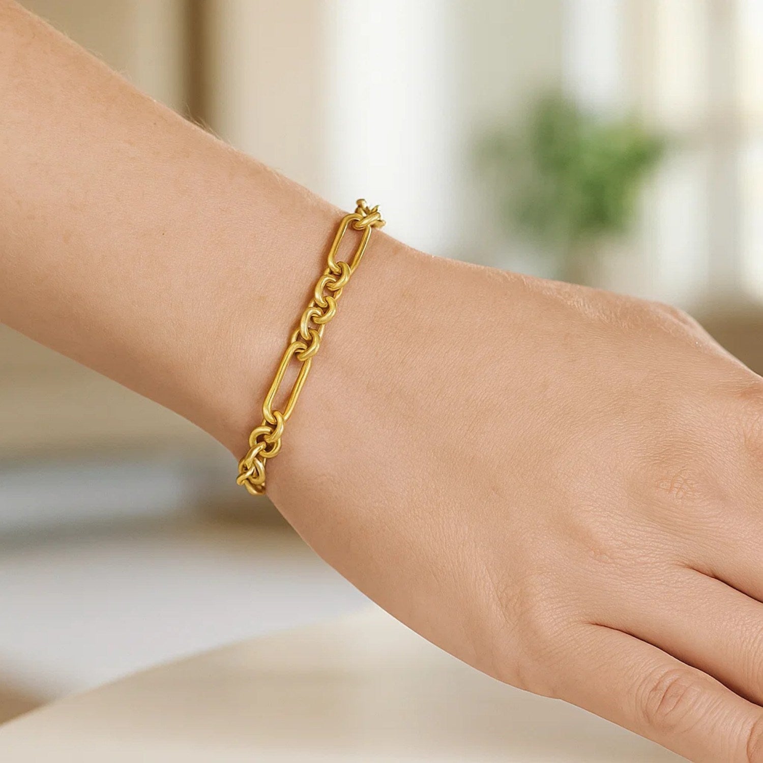 14k yellow gold modern paperclip link bracelet showcasing elegant chain design and luxurious shine.