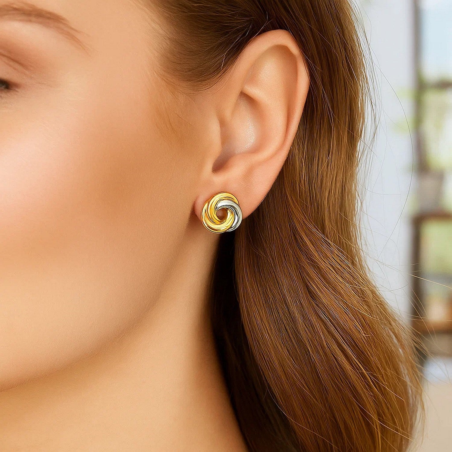 14k two-tone gold shiny dangle earrings featuring an elegant intertwined design for a modern touch.