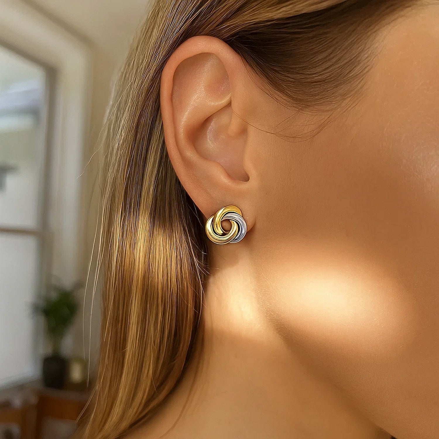 14k two-tone gold shiny dangle earrings featuring modern intertwined design for a luxurious statement look.