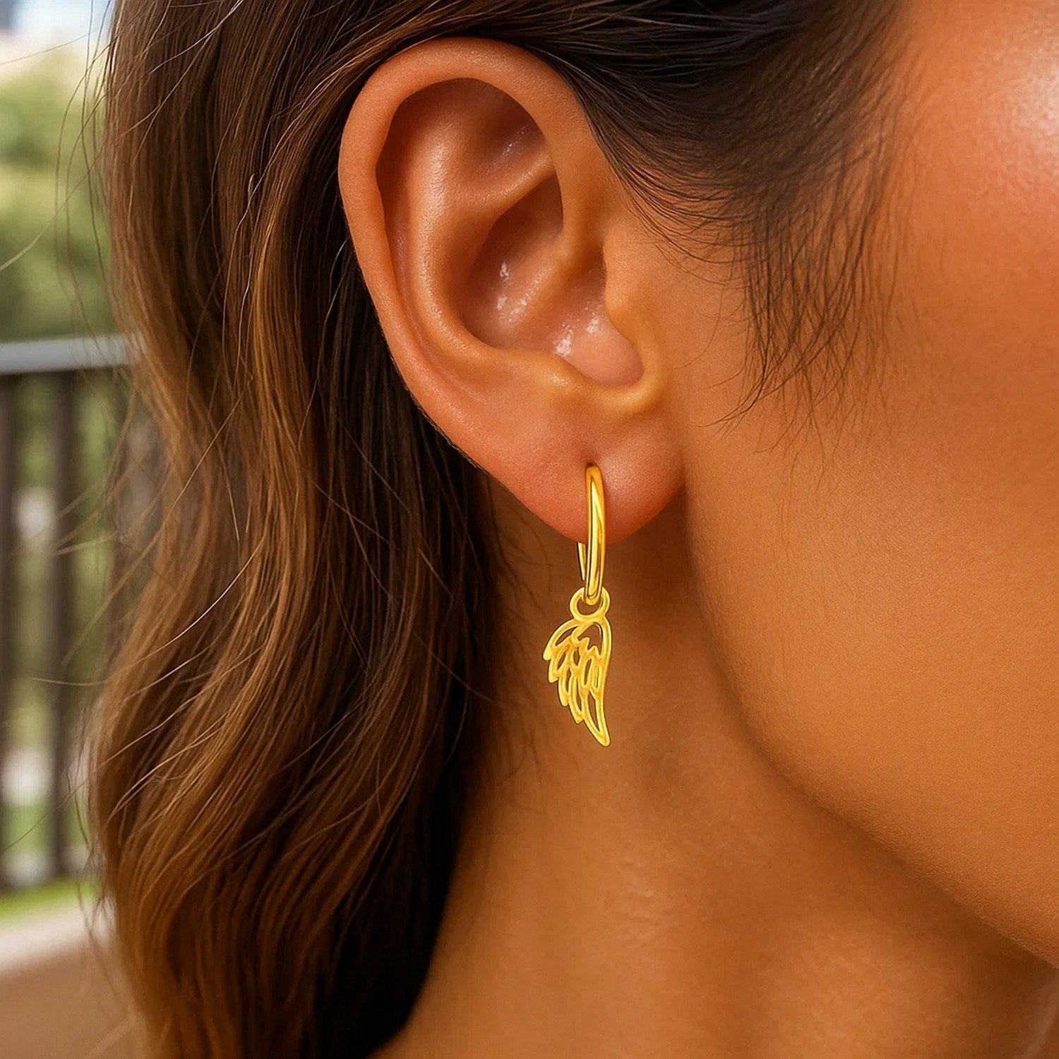 14k yellow gold hoop earrings featuring elegant angel wing design for a contemporary, luxurious look.