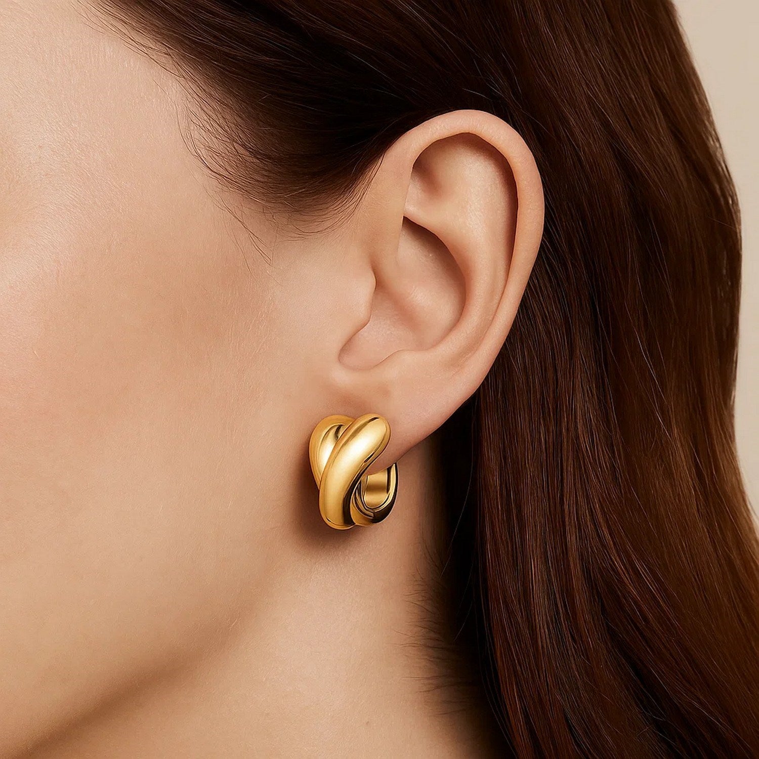 14k yellow gold modern crossover hoop earrings showcasing a sleek, elegant design for contemporary luxury.