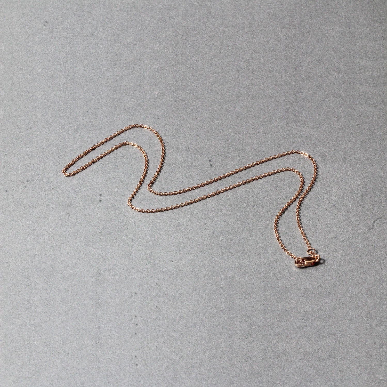 Elegant 14k rose gold round cable link chain, 1.25 mm, showcasing timeless luxury and exquisite craftsmanship.