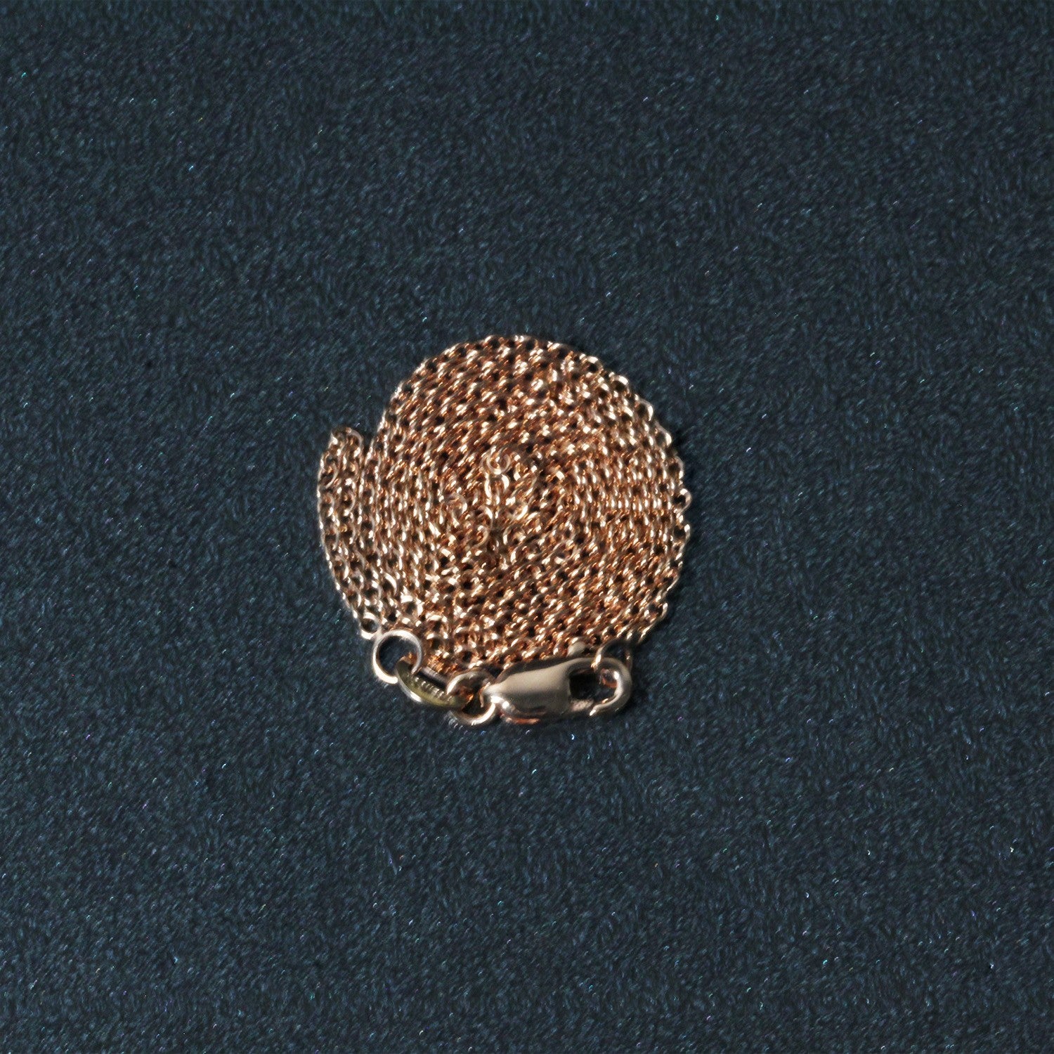 Elegant 14k rose gold round cable link chain, 1.25 mm, showcasing a refined and timeless design.