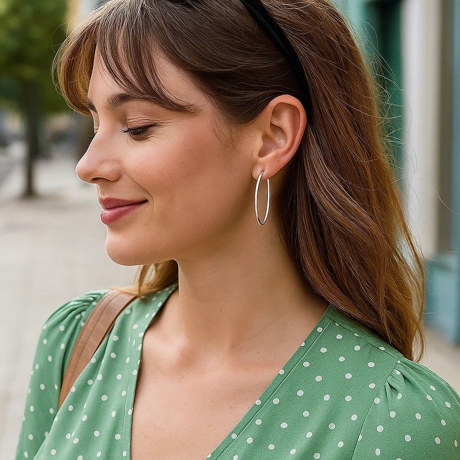 14k white gold polished slim oval hoop earrings, showcasing contemporary elegance and refined craftsmanship.