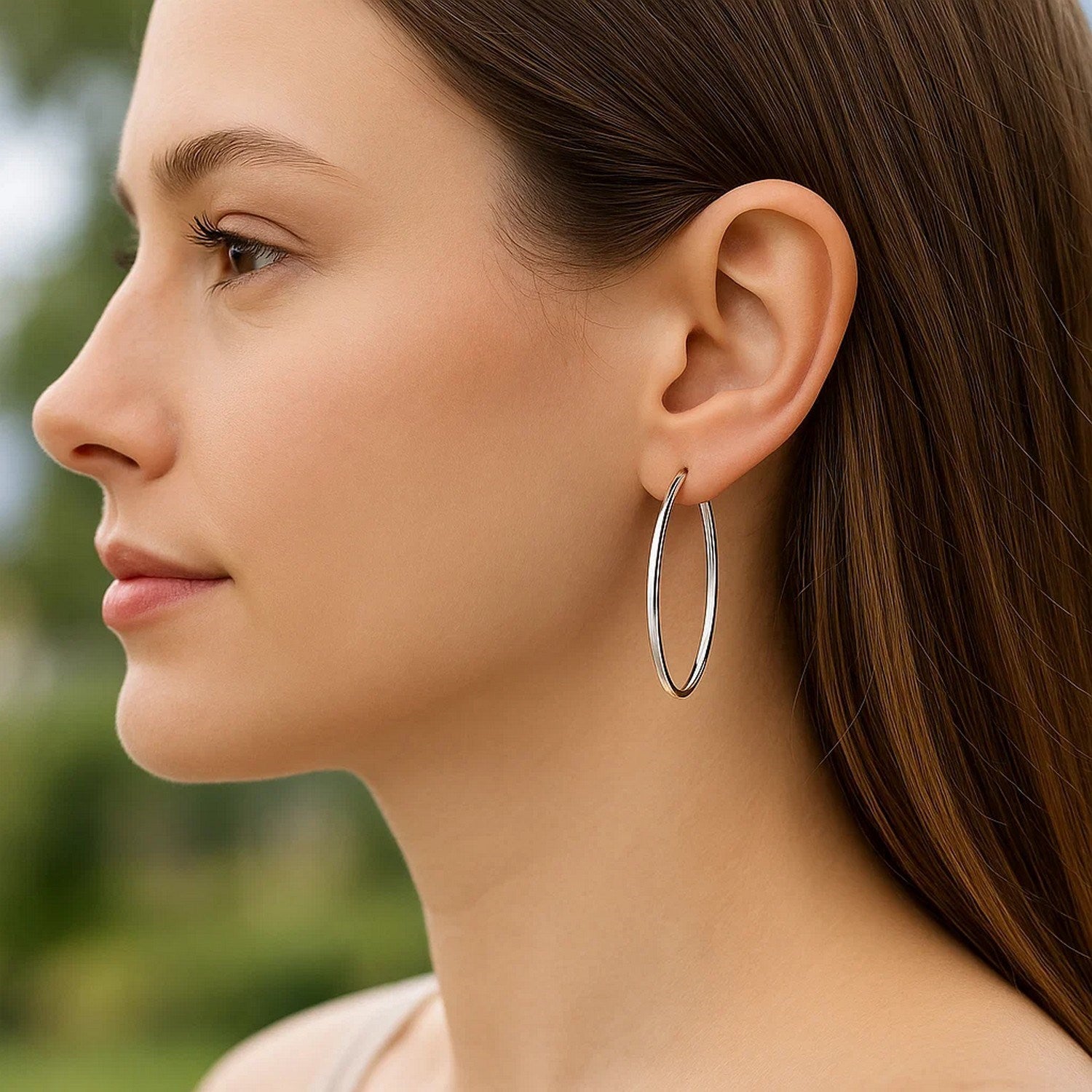 14k white gold polished slim oval hoop earrings, showcasing contemporary elegance and refined craftsmanship.