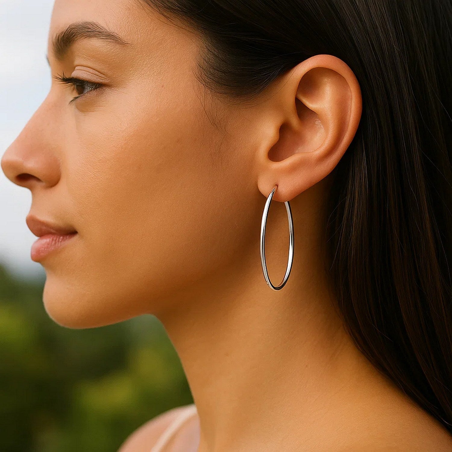 14k white gold polished slim oval hoop earrings with a contemporary design, perfect for elegant occasions.