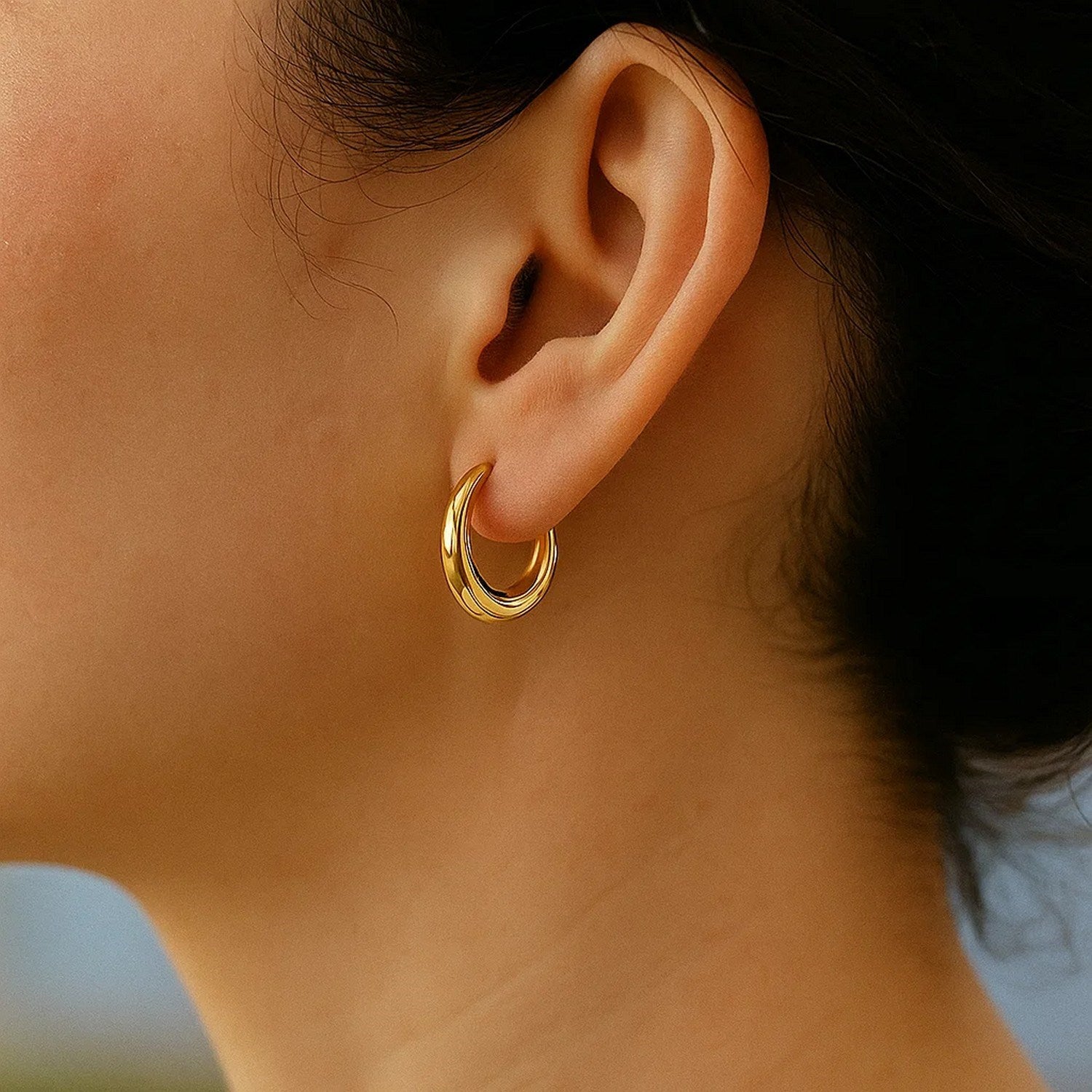 14k yellow gold polished oval hoop earrings featuring a contemporary design for elegant everyday wear.