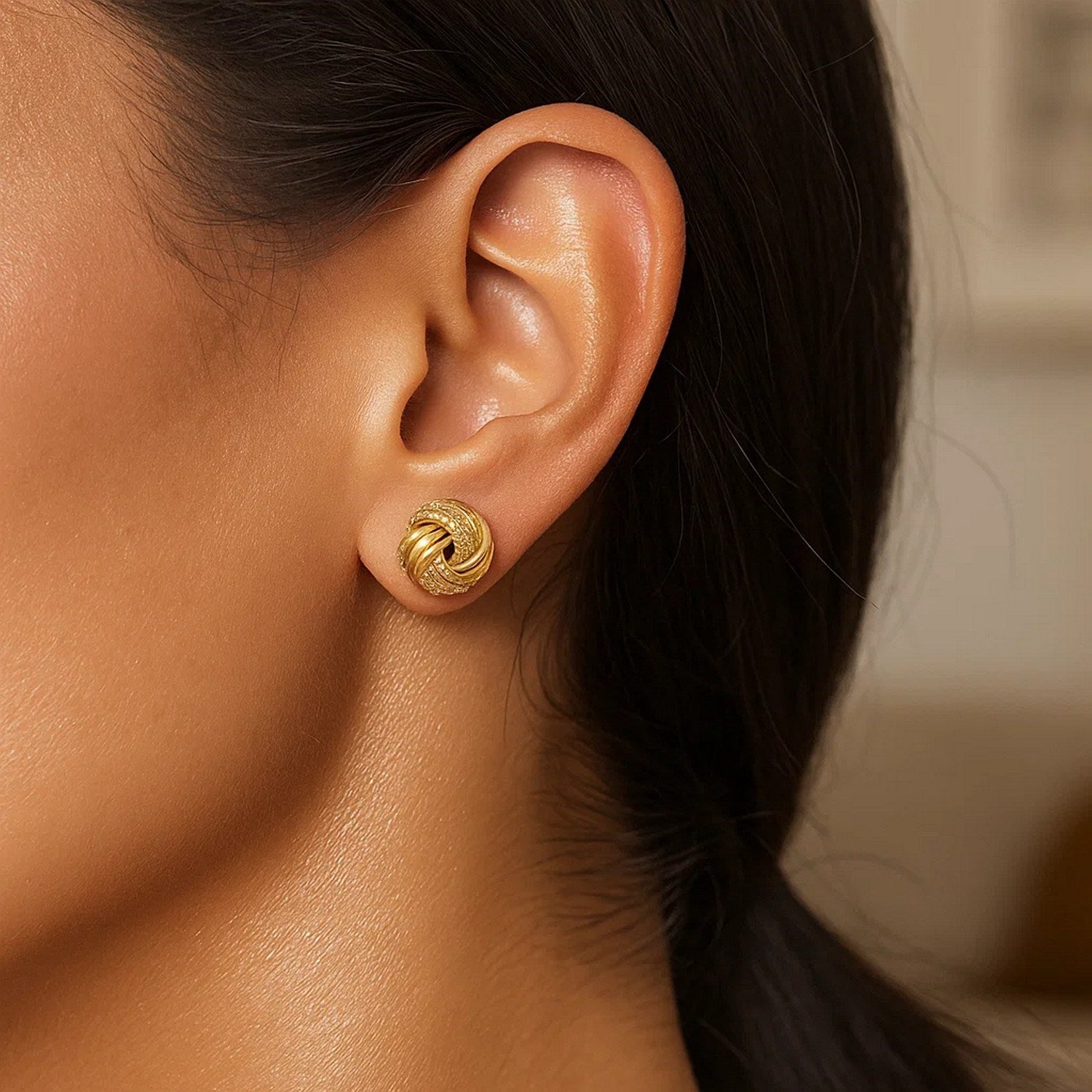 14k yellow gold textured love knot earrings showcasing modern elegance and luxurious craftsmanship.
