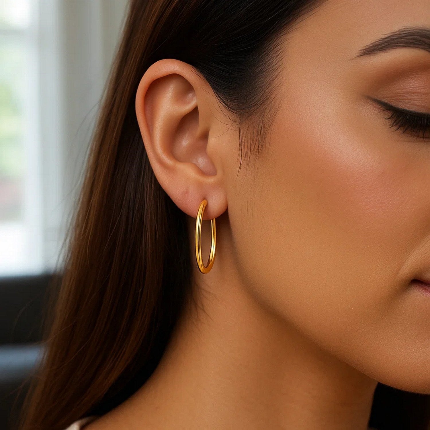 14k yellow gold modern endless oval hoop earrings showcasing elegant craftsmanship and timeless design.