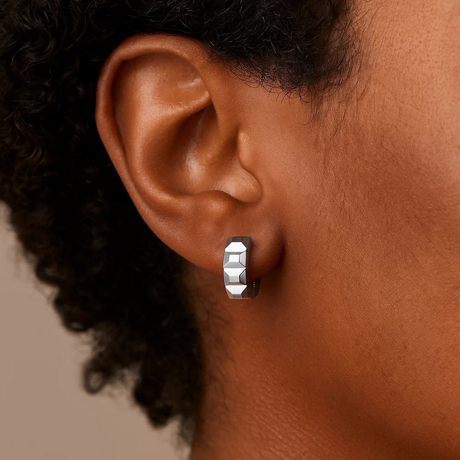14K white gold faceted huggie earrings showcasing a modern design with a sleek, polished finish.
