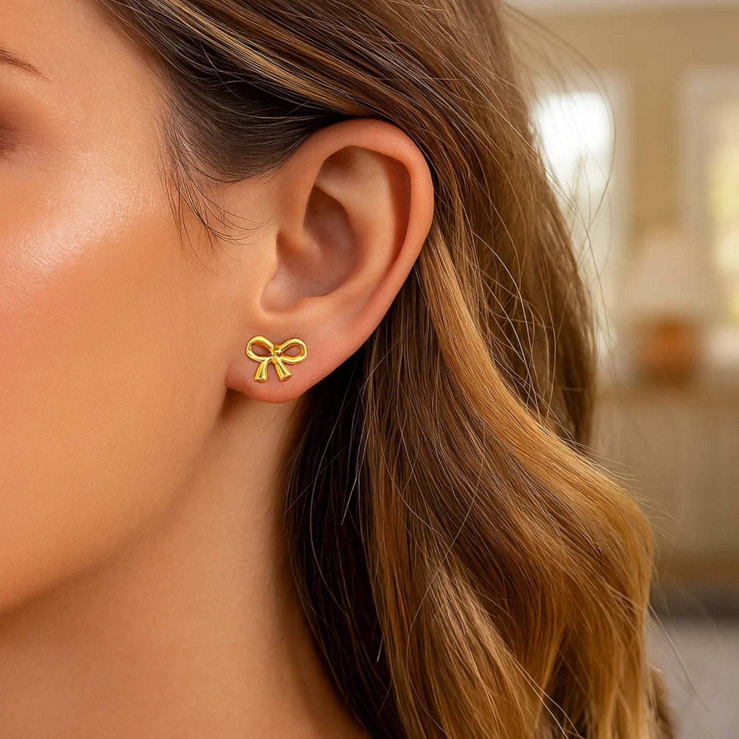 14k yellow gold bow style earrings featuring a modern design, perfect for adding luxury to any ensemble.