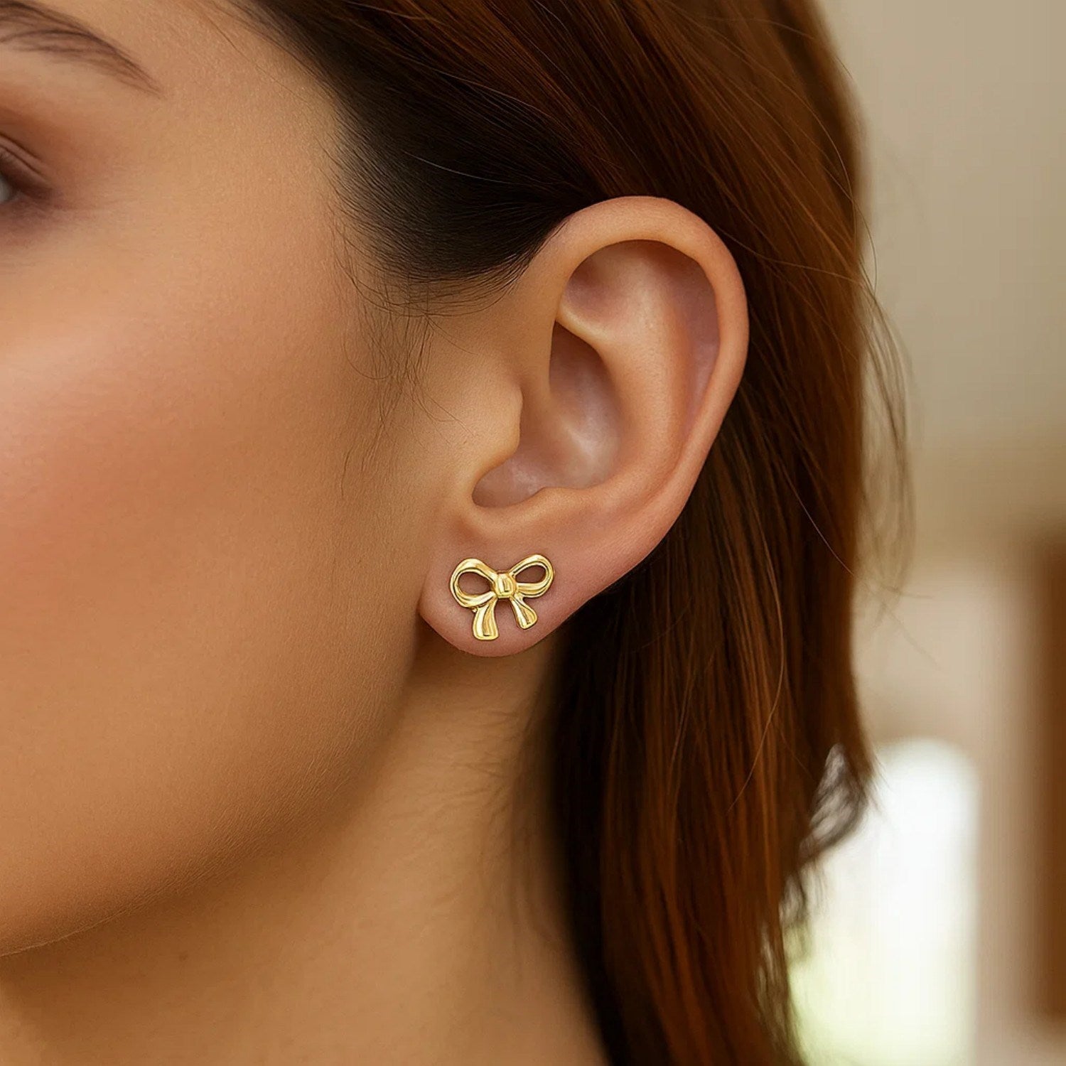 14k yellow gold bow style earrings featuring a modern design for a luxurious touch to any ensemble.