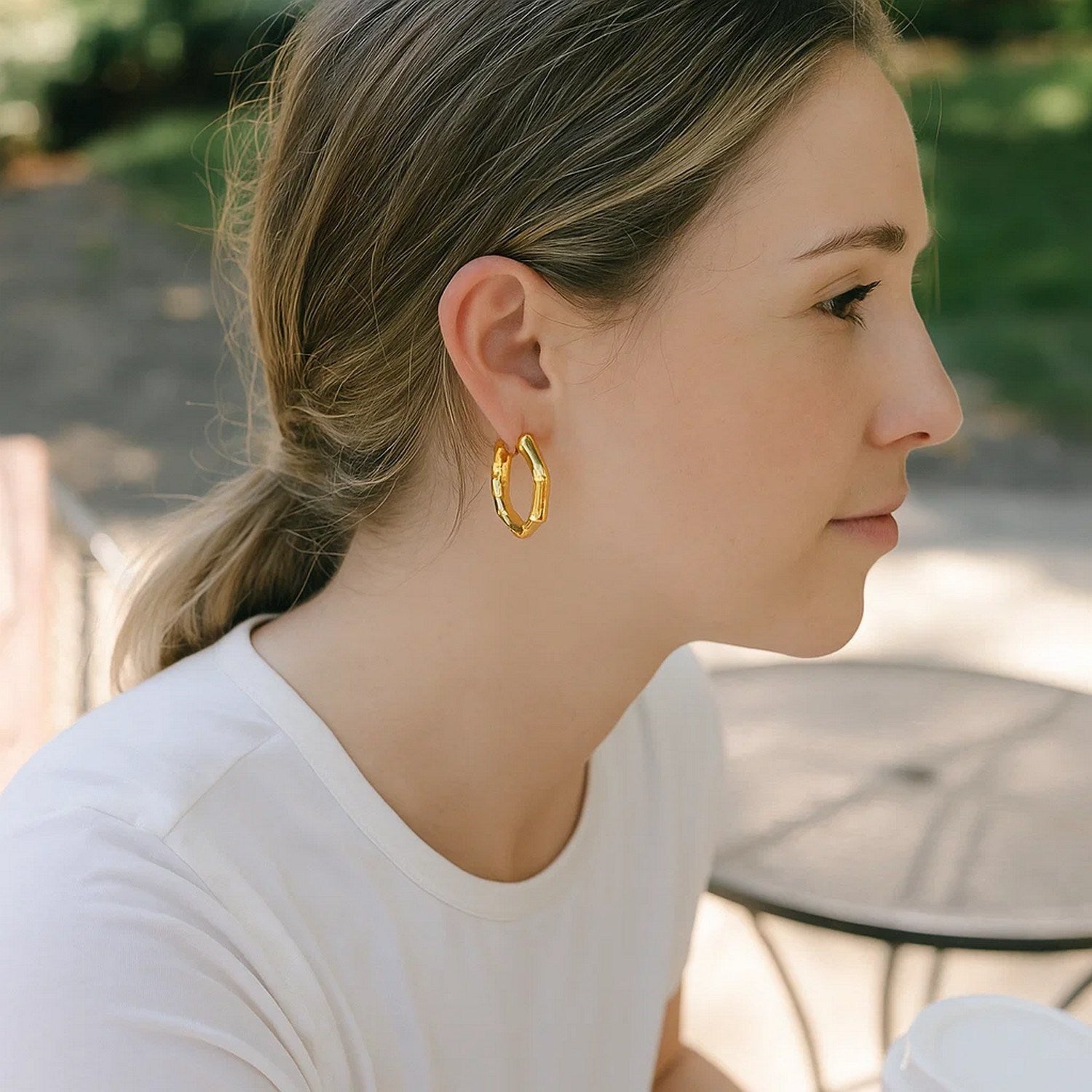 14k yellow gold polished bamboo hoop earrings showcasing a modern design and elegant shine, perfect for any occasion.