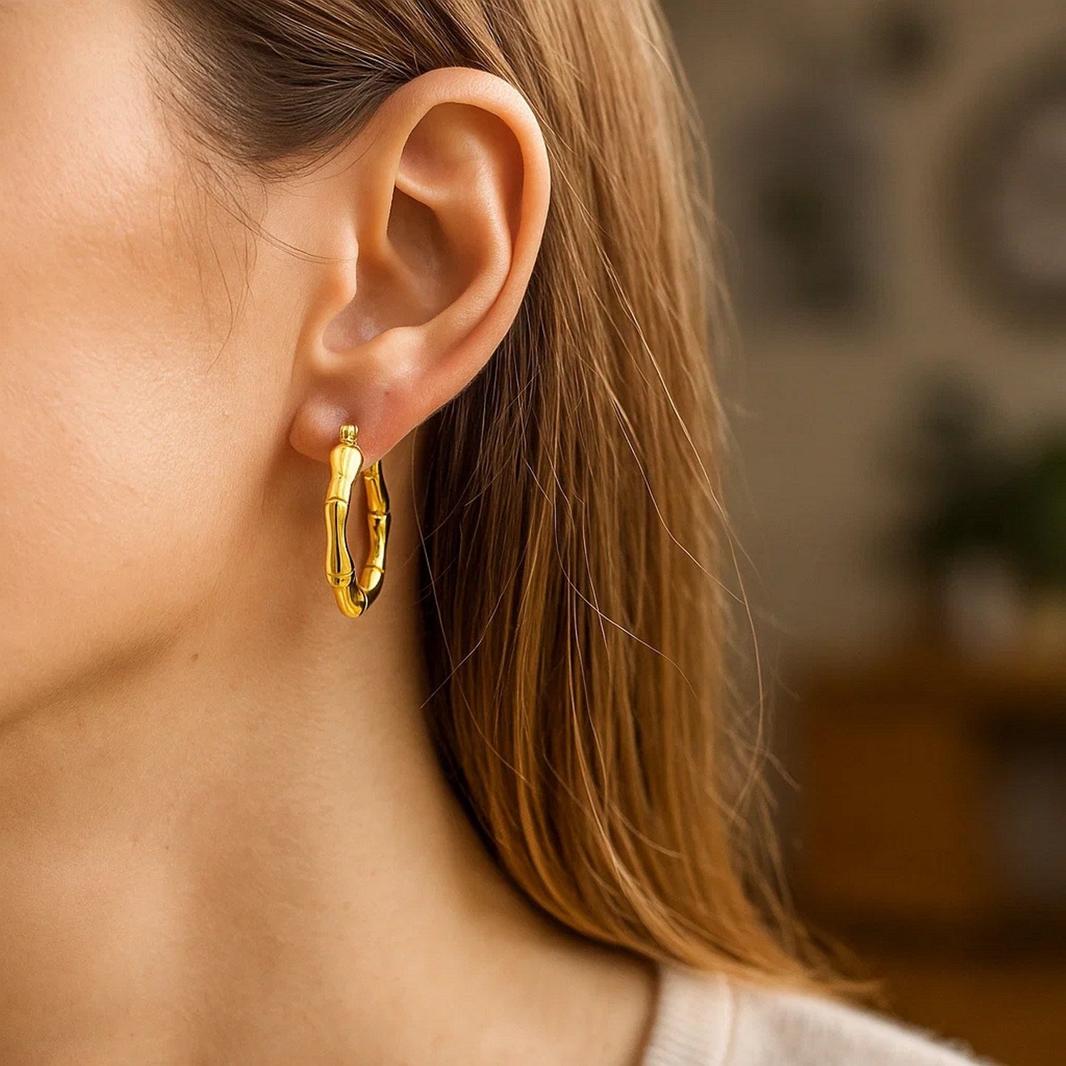 14k yellow gold polished bamboo hoop earrings with a modern design, perfect for elegant everyday wear.