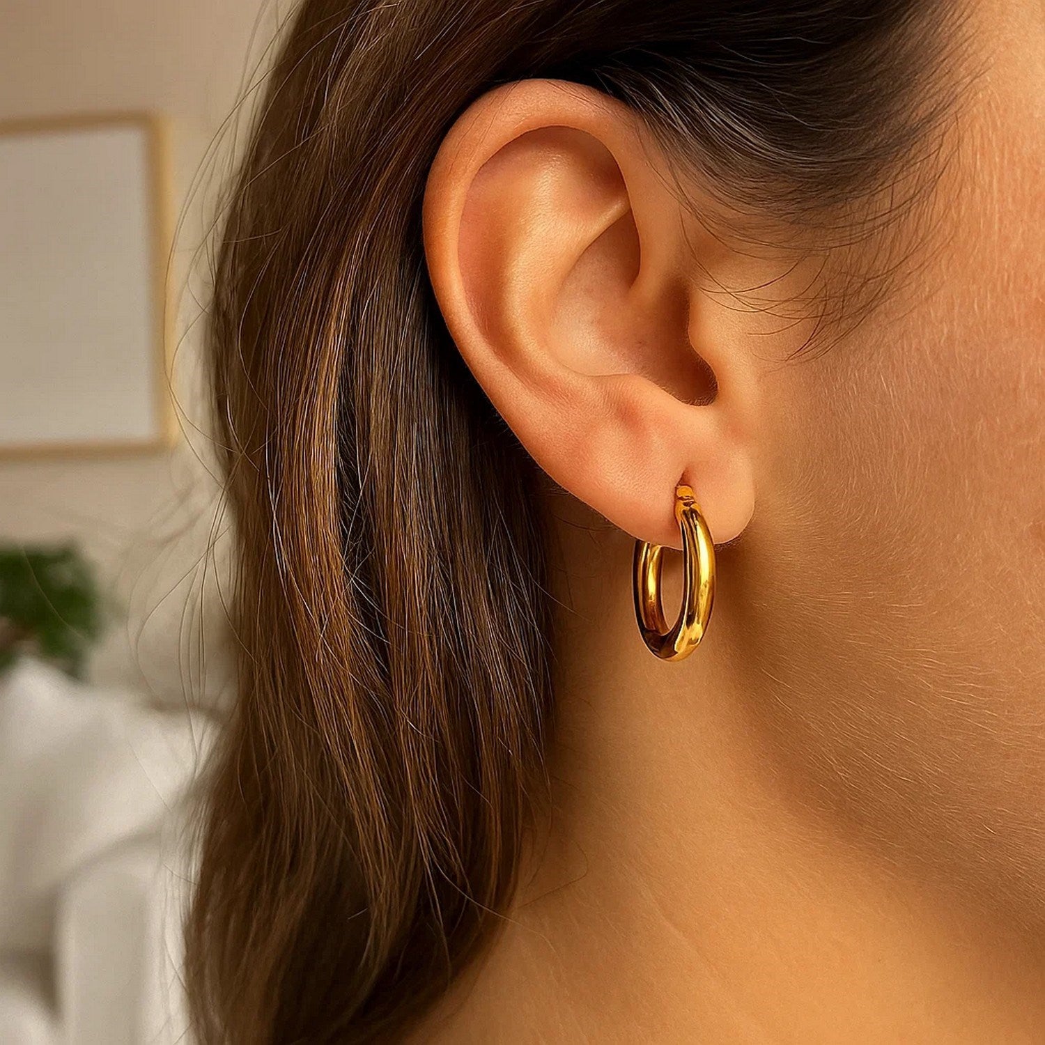 14k yellow gold polished hoop earrings with a modern design, showcasing elegance and timeless sophistication.
