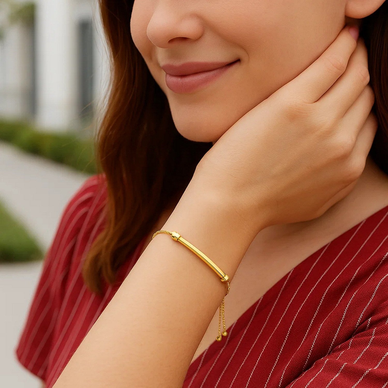 14k yellow gold smooth curved bar bracelet with lariat style and sparkling diamond accents, perfect for modern elegance.