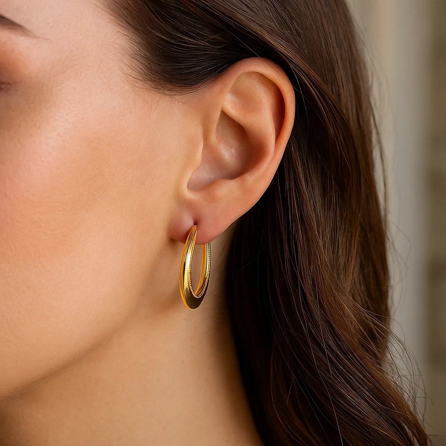 Elegant 14k yellow gold round hoop earrings with a textured rope design, perfect for sophisticated occasions.