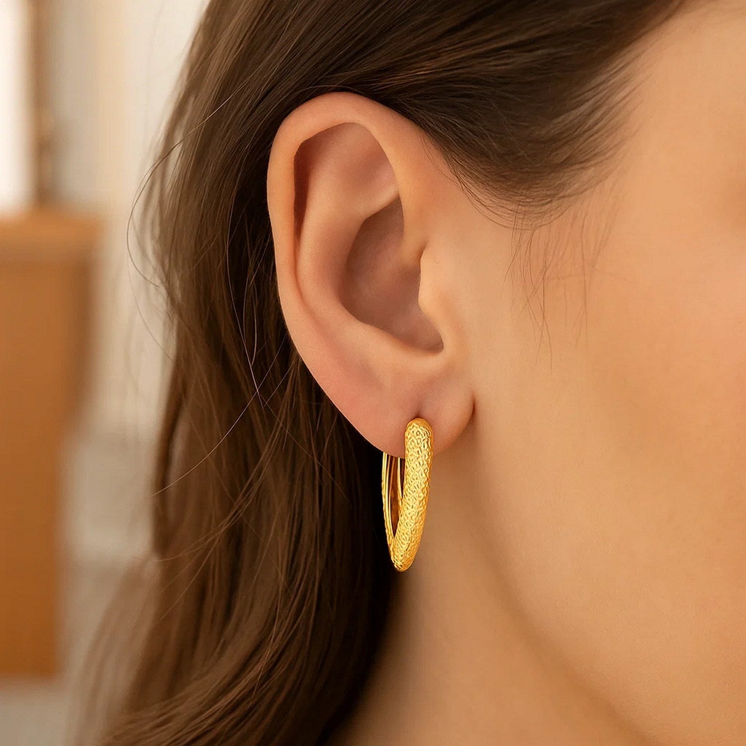 14k yellow gold modern V-shaped puffed hoop earrings, showcasing a sleek and elegant design for sophisticated style.