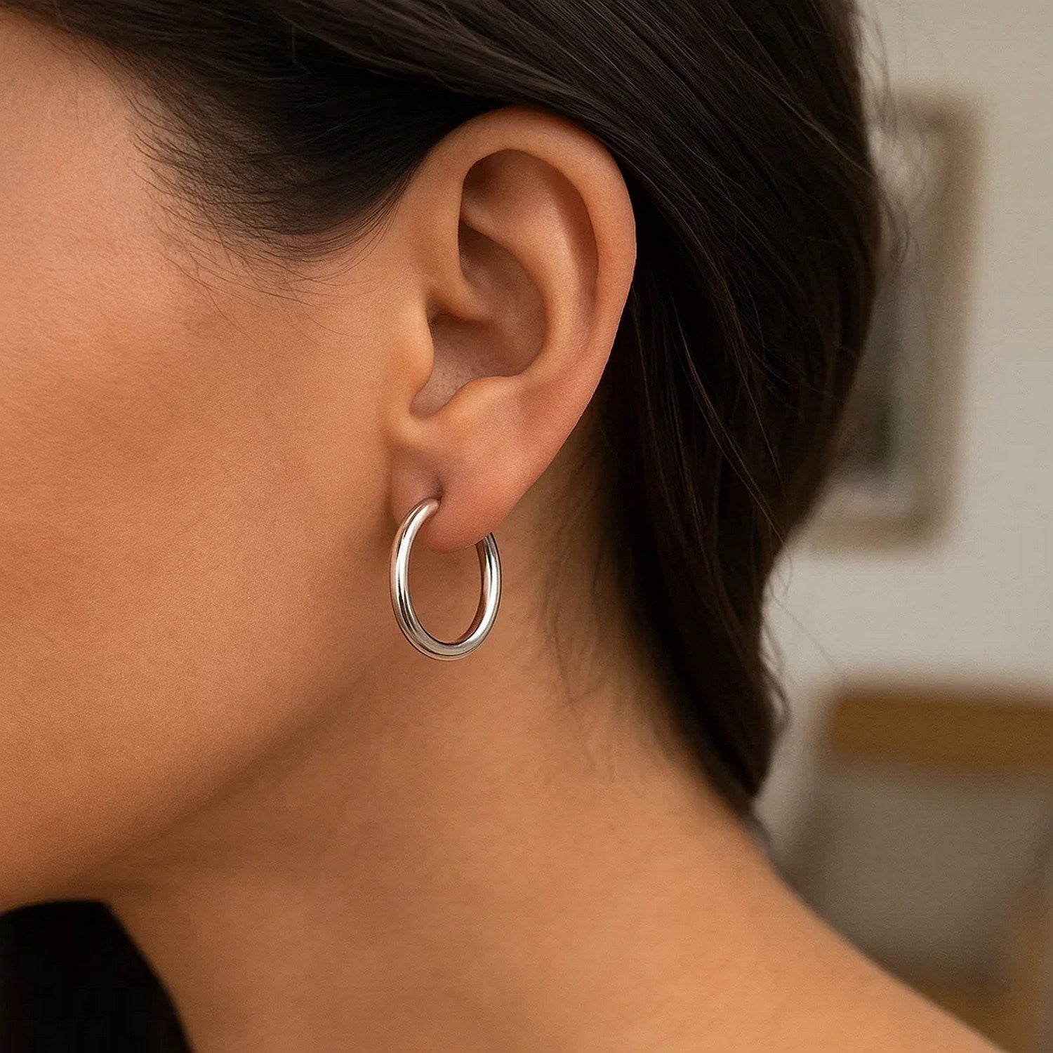 Elegant 14k white gold polished hoop earrings showcasing a sleek design, perfect for sophisticated occasions.