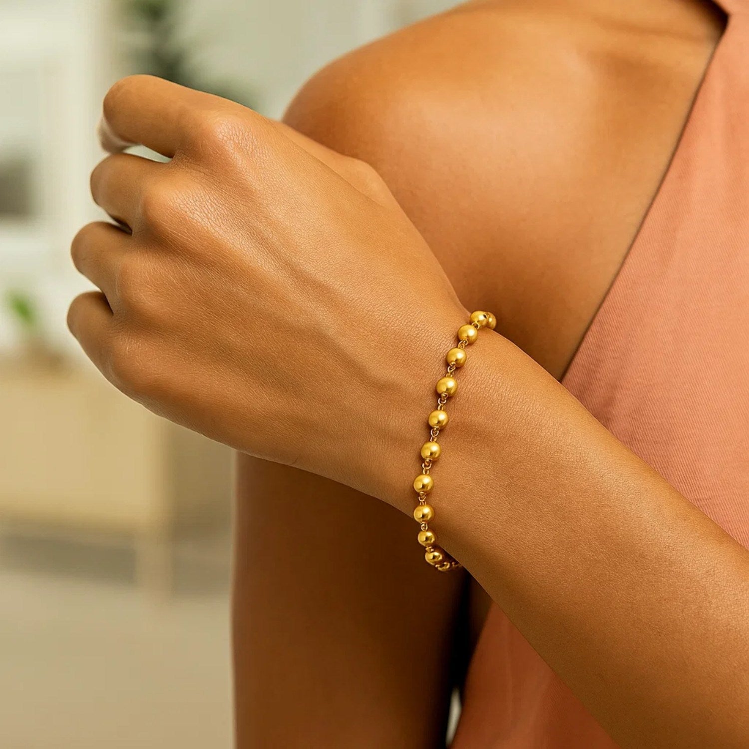 14K yellow gold polished pebble bead bracelet with elegant chain design, perfect for sophisticated styling.