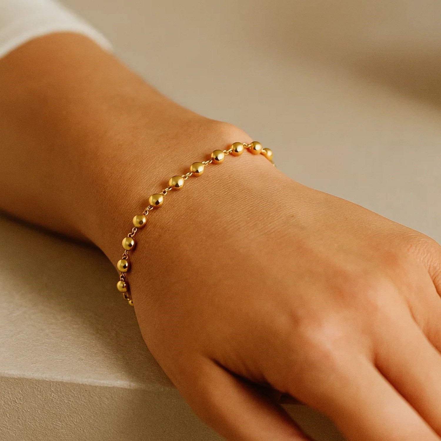 14k yellow gold polished pebble bead bracelet with elegant chain design, showcasing refined luxury and timeless style.