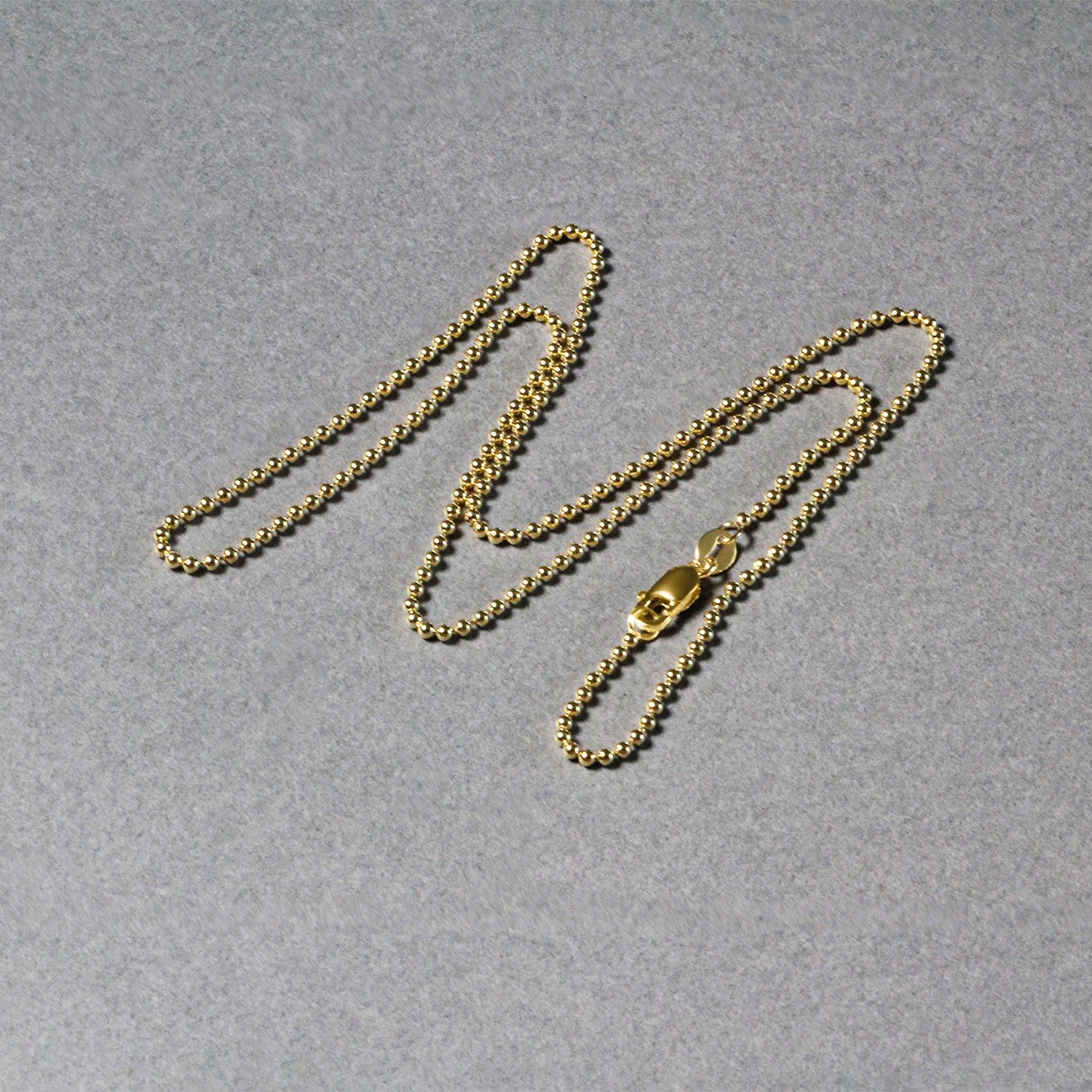14k yellow gold minimalist bead chain, 1.5mm, featuring exquisite diamond accents for a refined elegance.