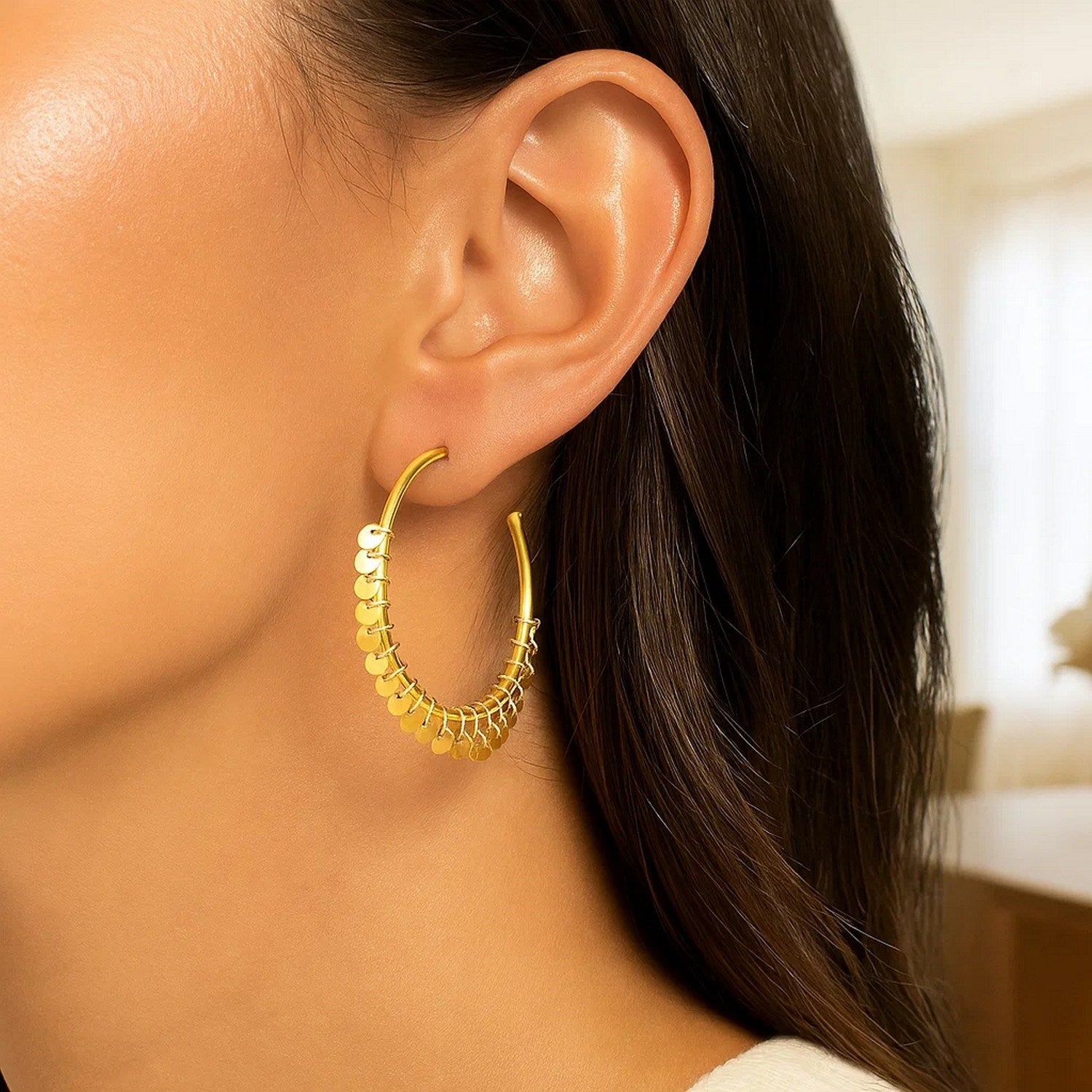 14k yellow gold hoop earrings adorned with modern dangling sequins for a chic, elegant look.