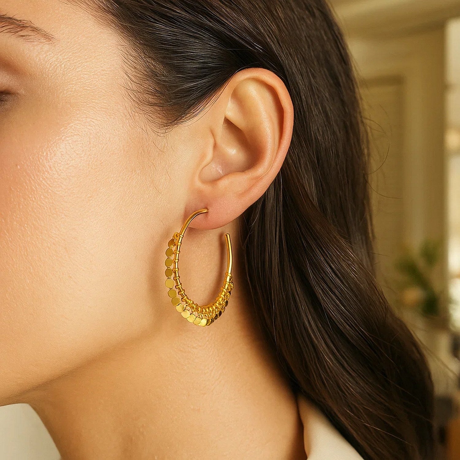 14k yellow gold modern hoop earrings adorned with elegant dangling sequins for a luxurious touch.